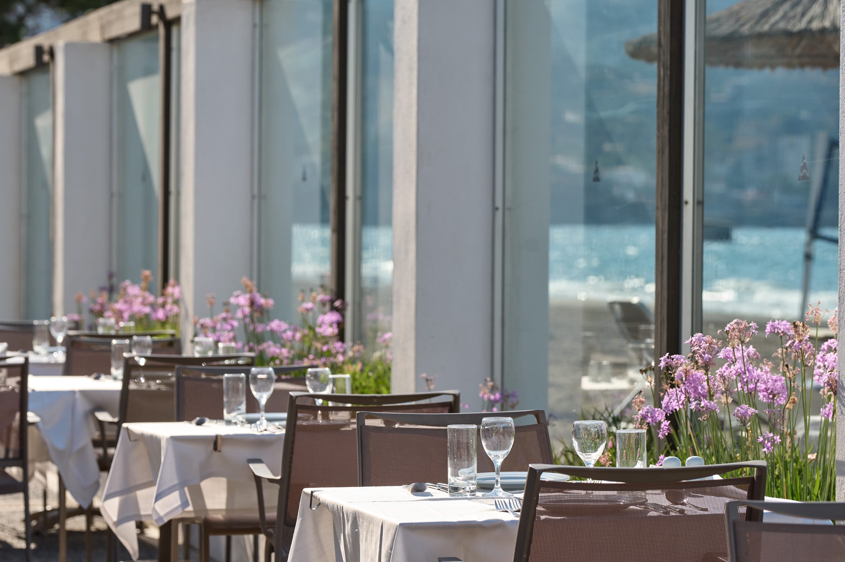 a set of tables and chairs in a room with a large window