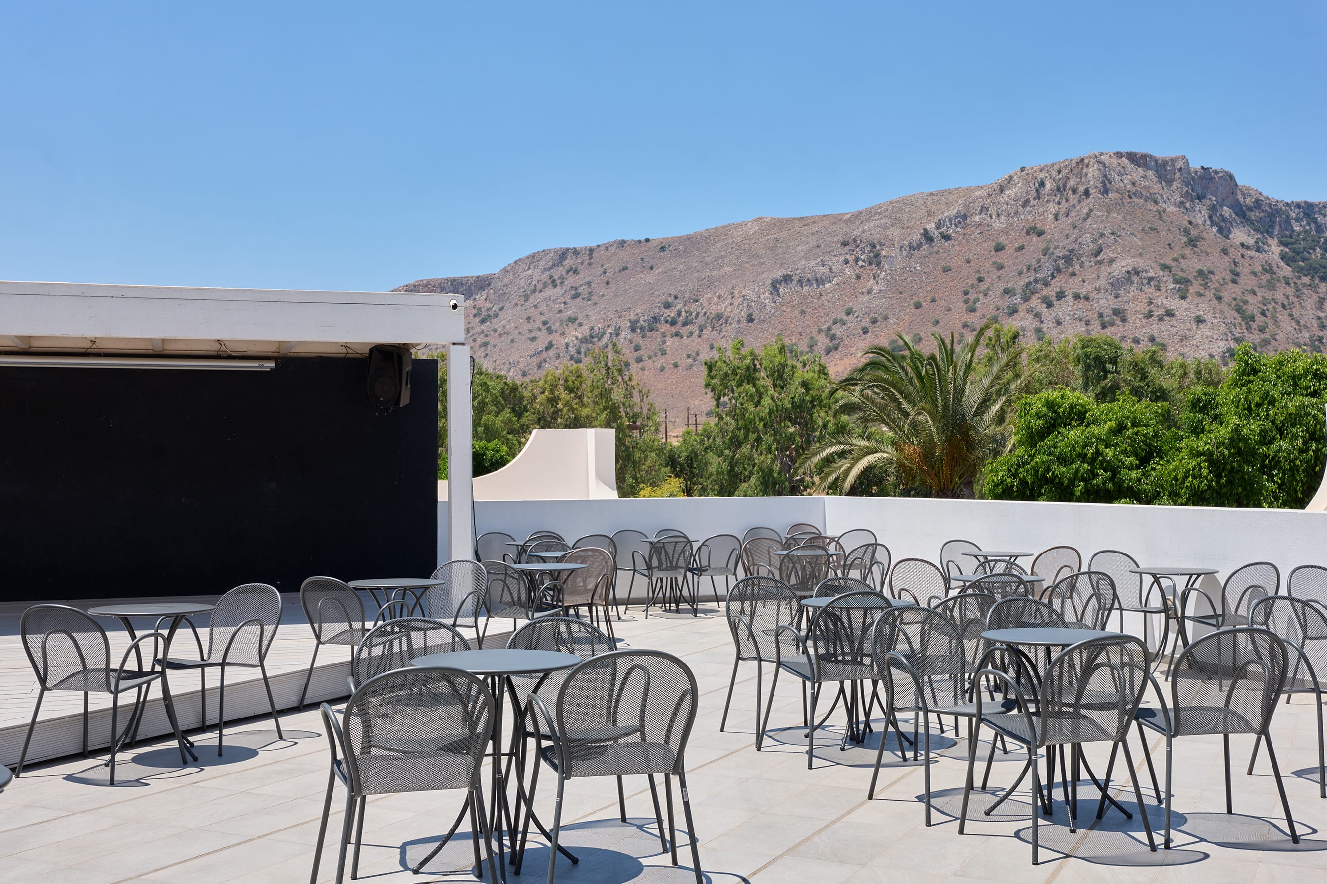 a patio with tables and chairs