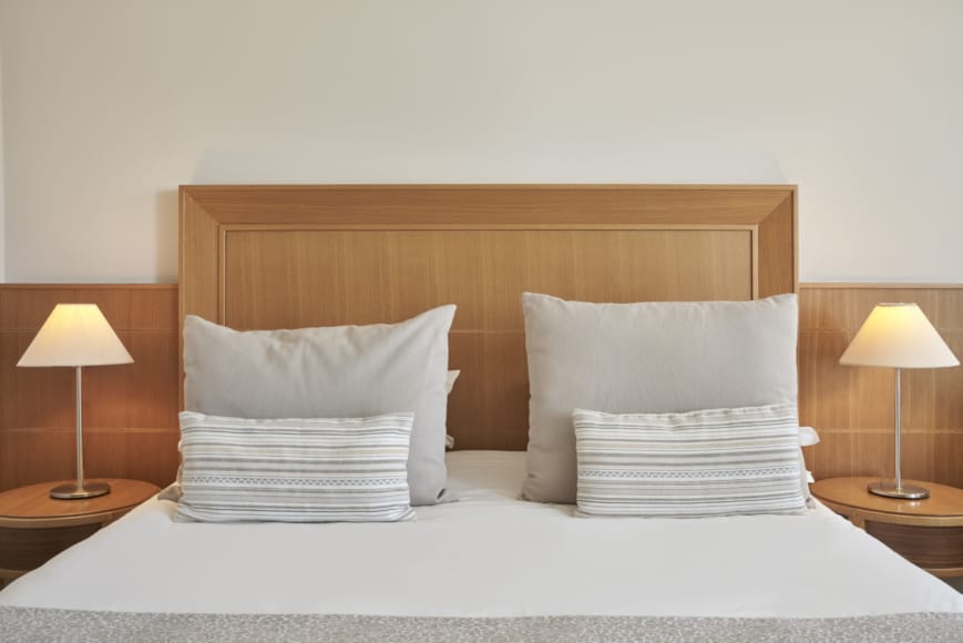 a bed with lamps on either side
