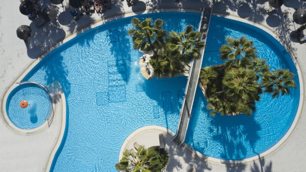 a pool with trees and a pole