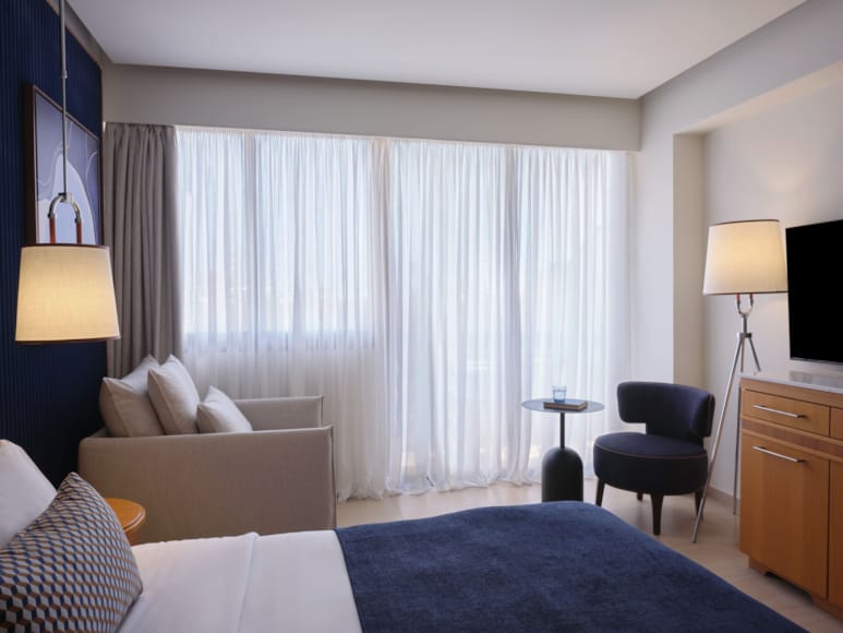 a room with a bed and lamps