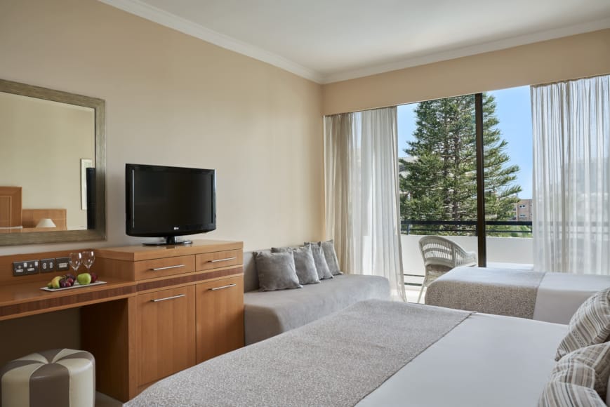 a bedroom with a tv and couches