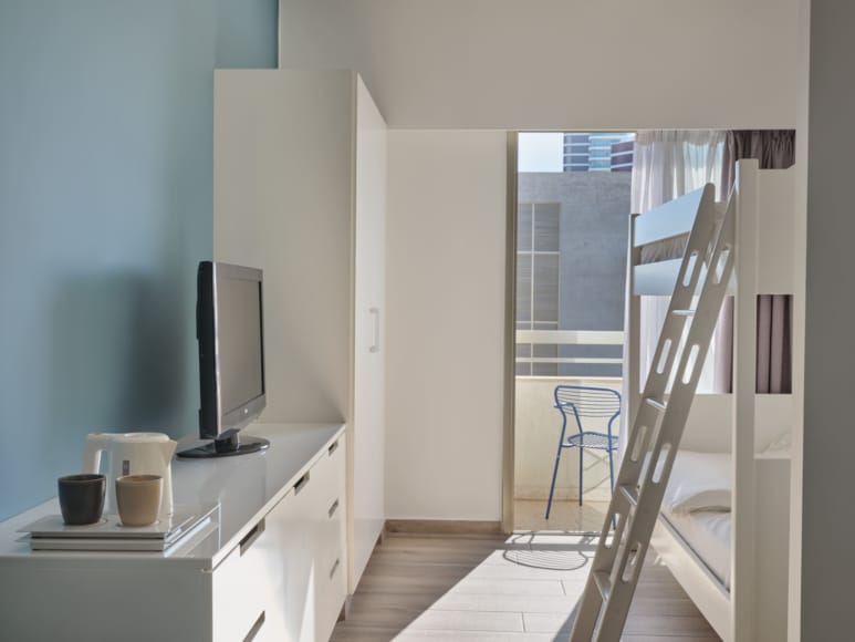 a room with a tv and a ladder
