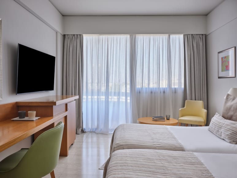 a room with a bed and a tv
