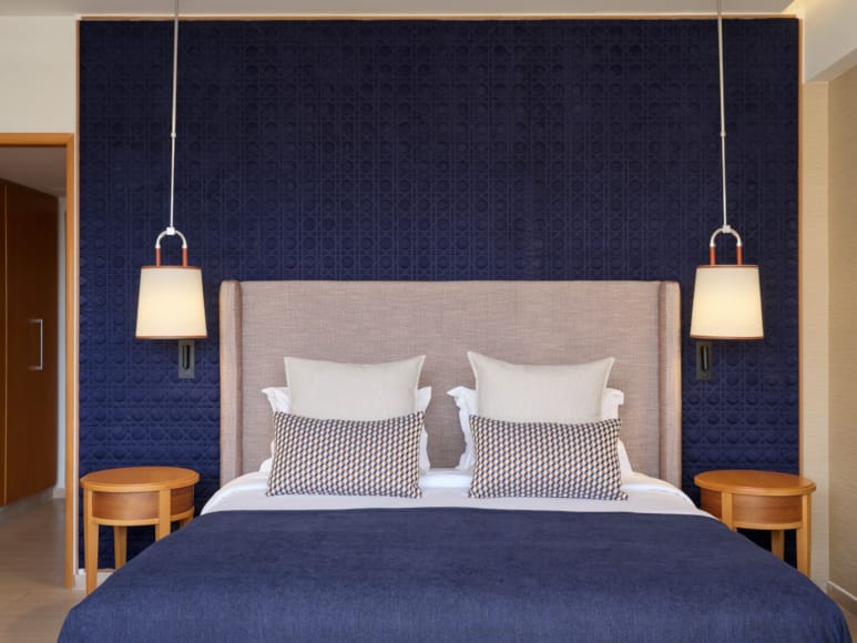 a bed with a blue curtain