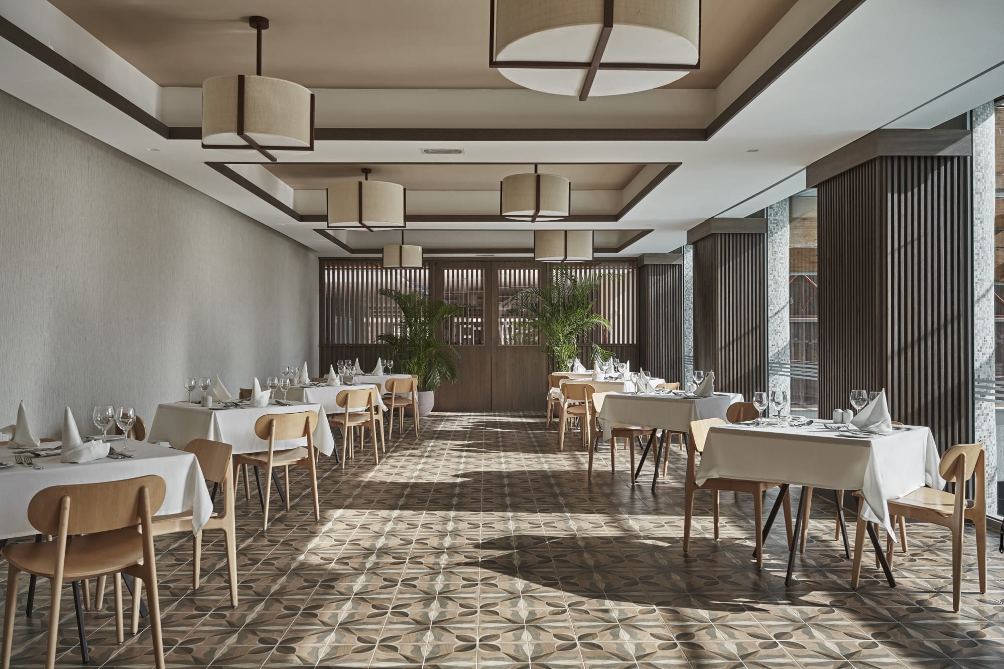 Modern Indoor Dining Room With Natural Light And Elegant Table Setup At Atlantica Oasis Hotel In Limassol