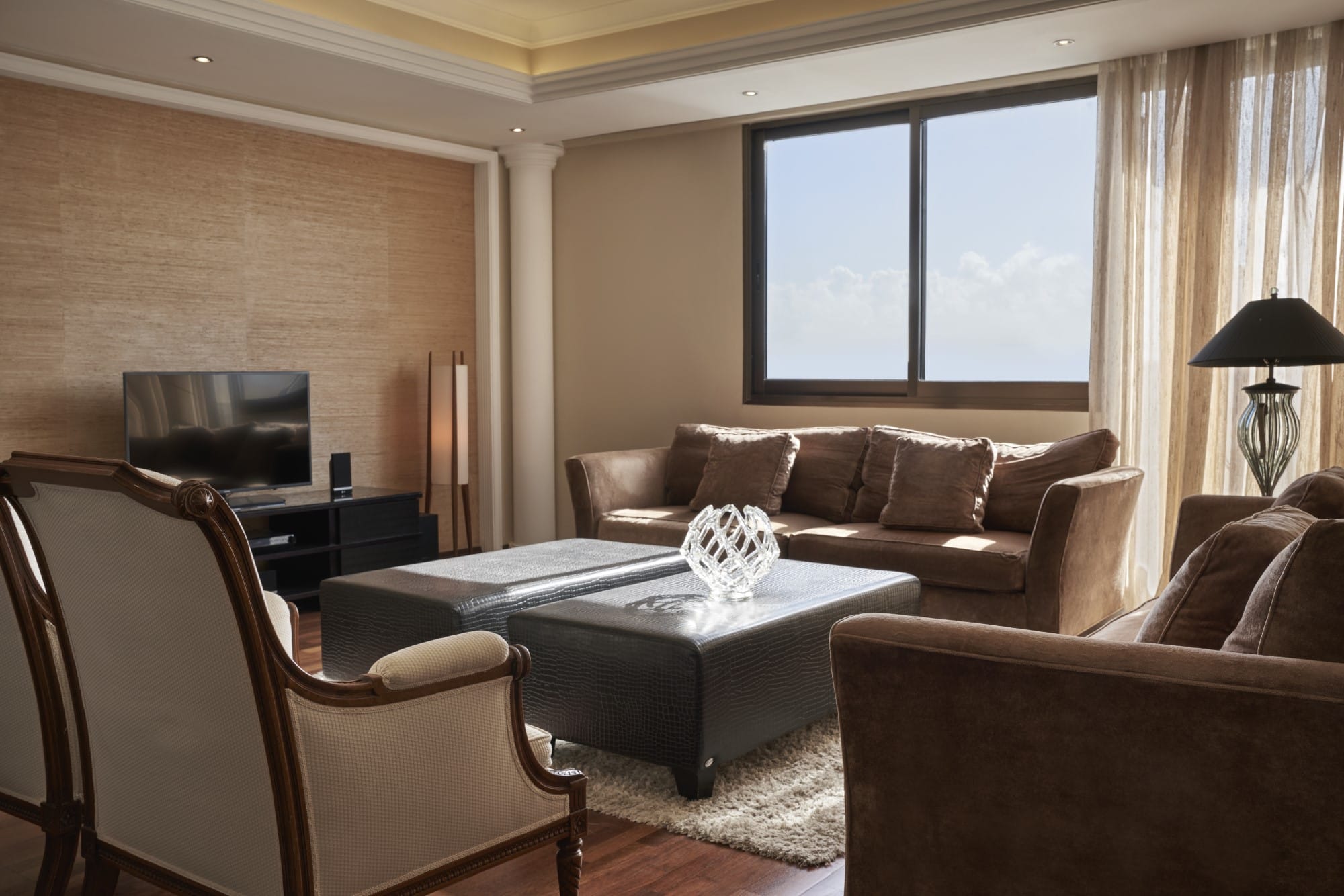 Elegant Suite Living Area With Comfortable Seating At Atlantica Oasis Hotel In Limassol