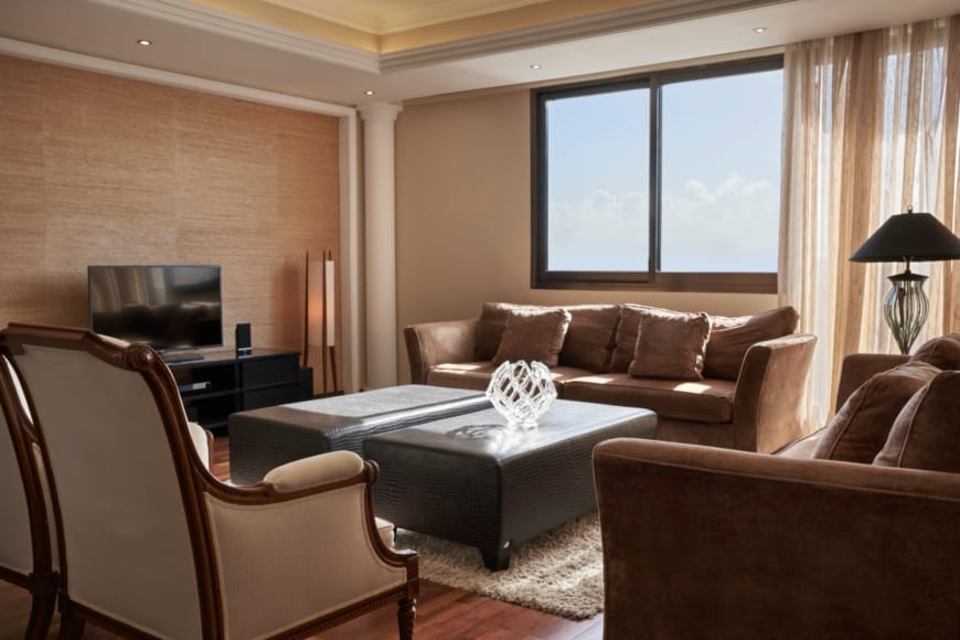 Elegant Suite Living Area With Comfortable Seating At Atlantica Oasis Hotel In Limassol
