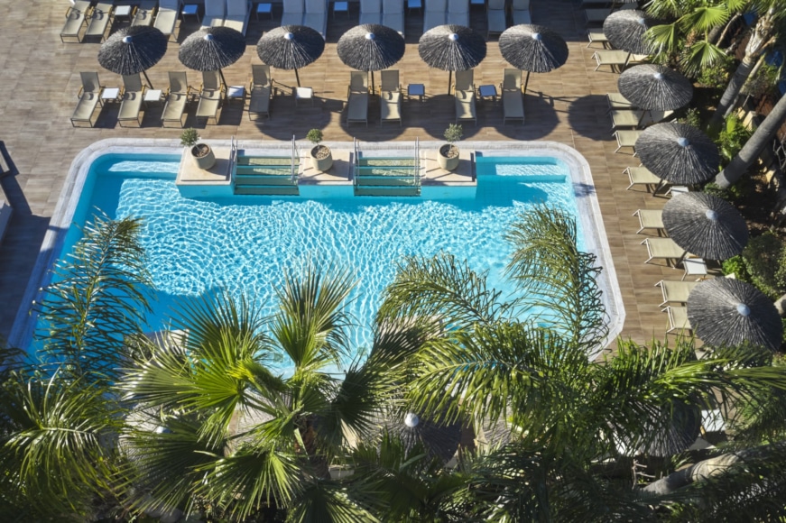 a pool with chairs around it