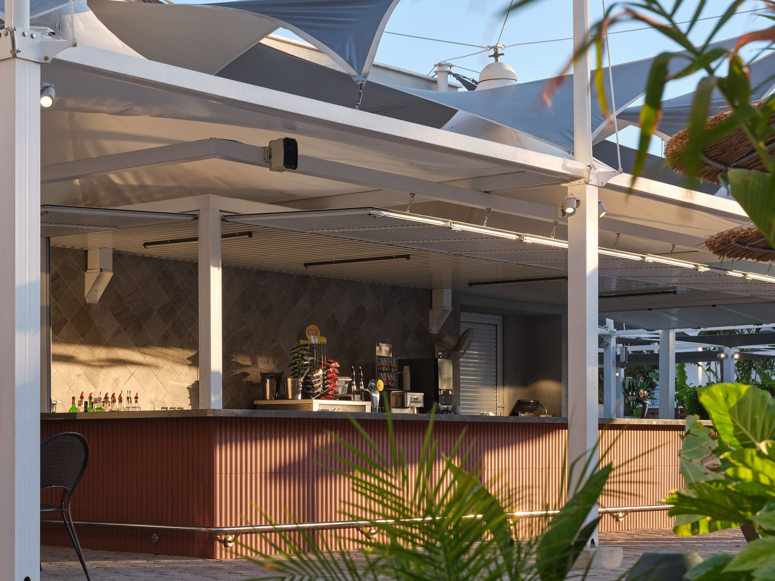 Outdoor Pool Bar Area At Atlantica Oasis Hotel In Limassol With Modern Design And Tropical Plants