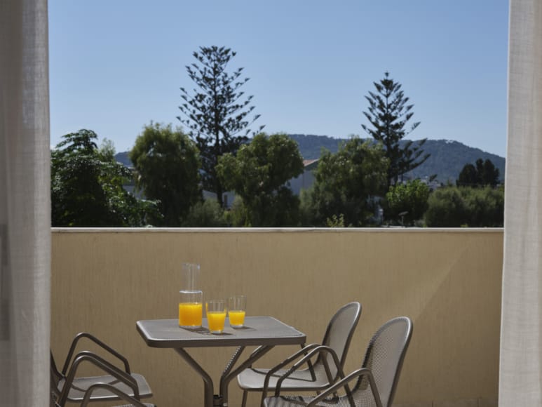 a table with glasses of liquid on it by a window