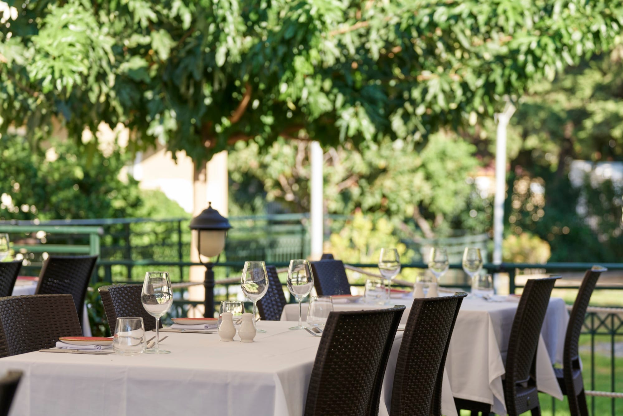 a set dining table with glasses and plates on it