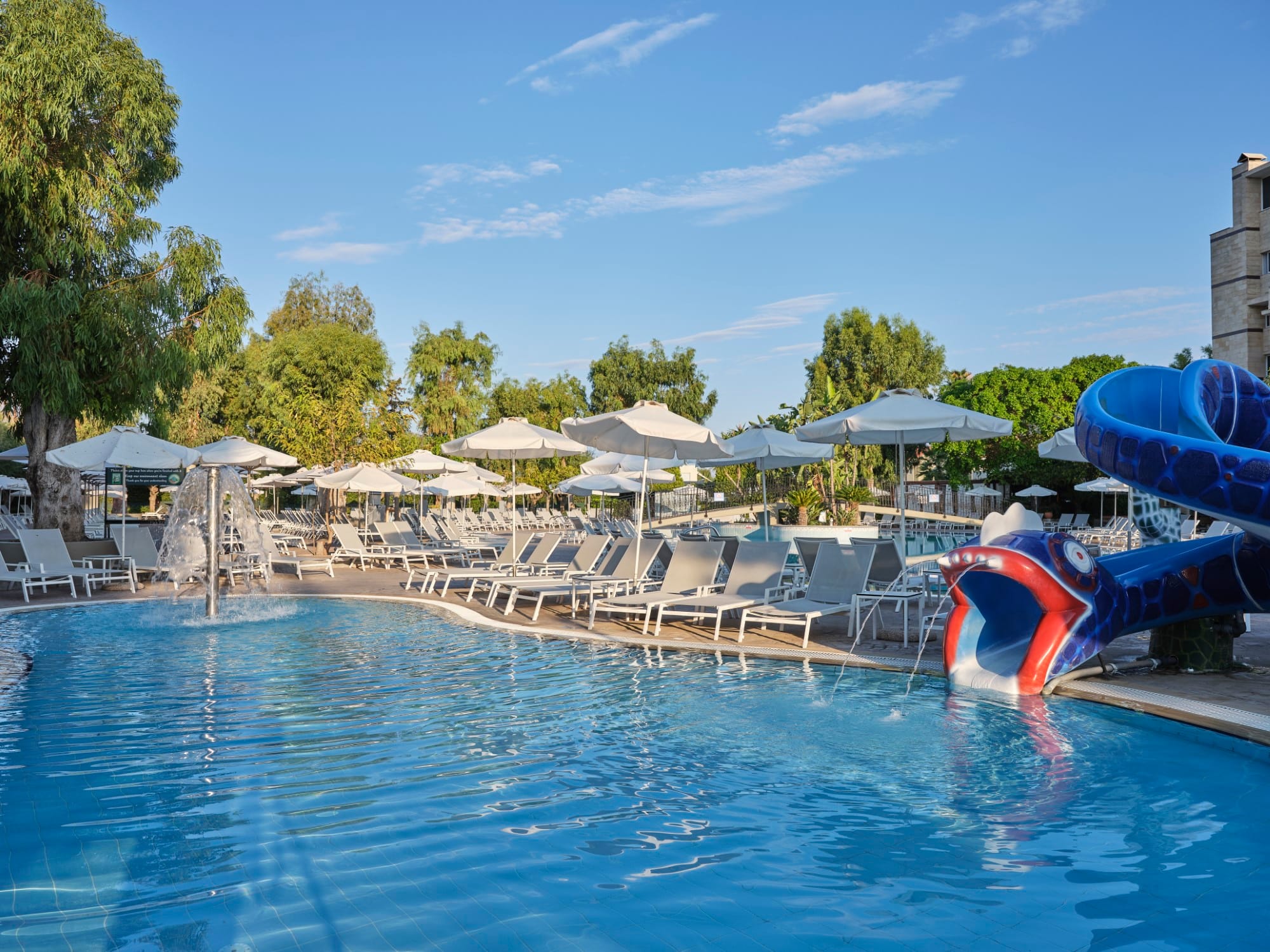 a pool with chairs and umbrellas