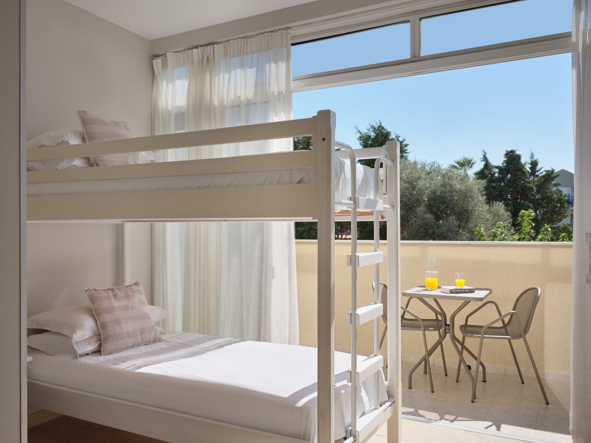 a bed and a table in a room with a window