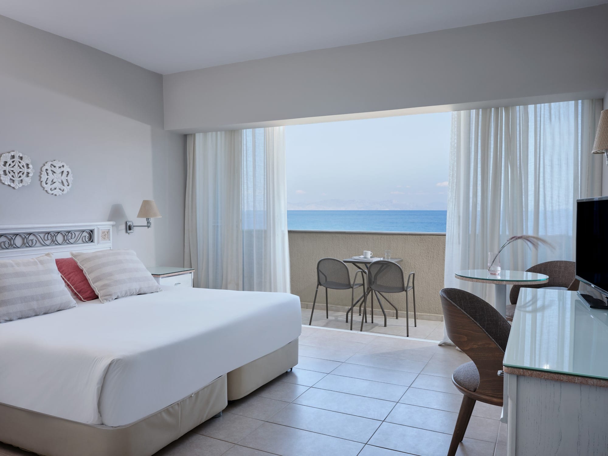 a bedroom with a bed and chairs