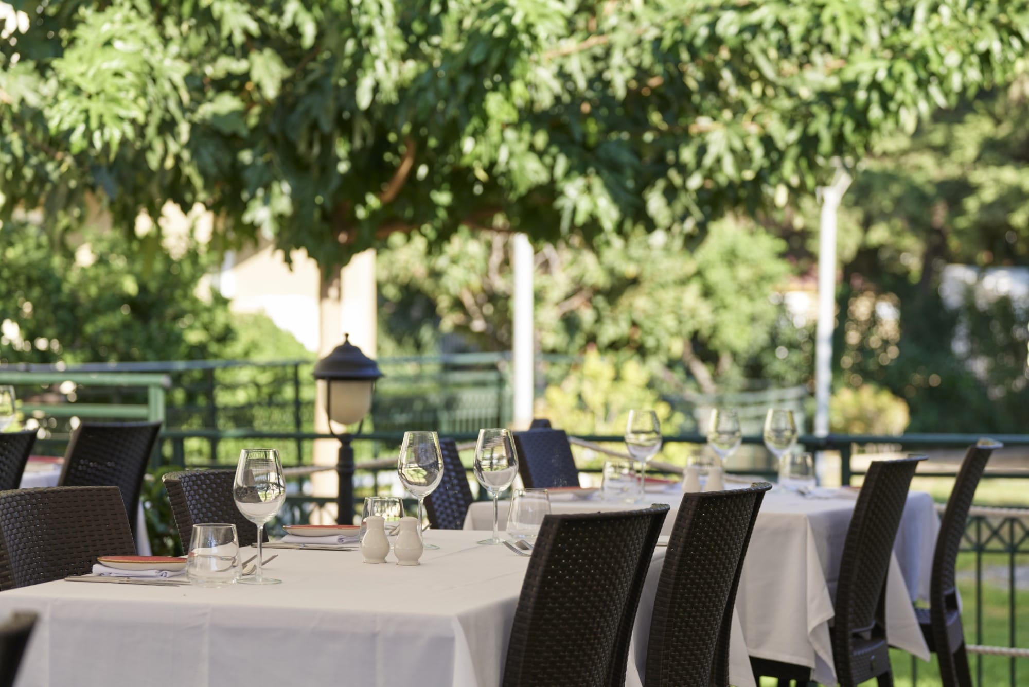 a set dining table with glasses and plates on it