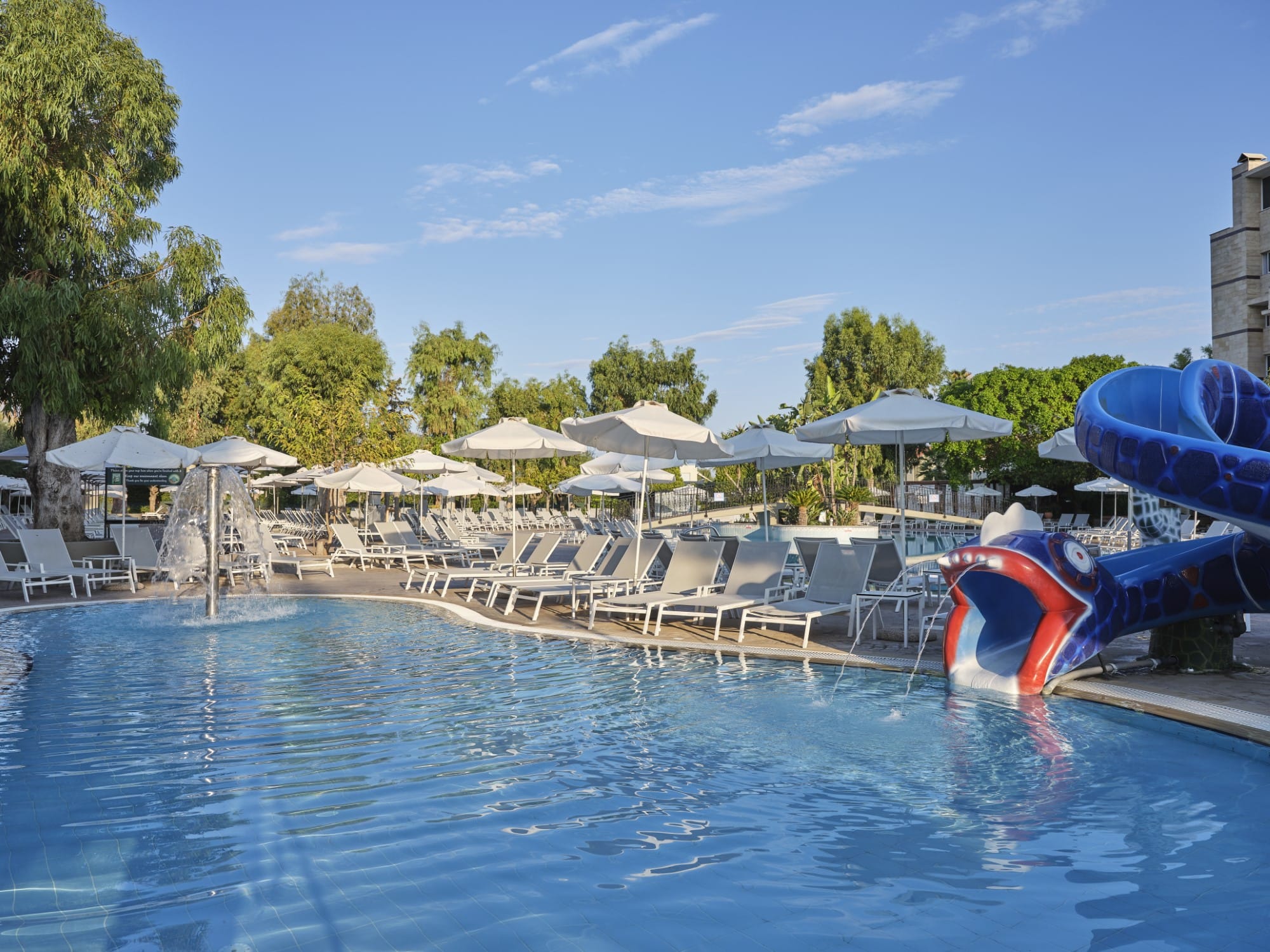 a pool with chairs and umbrellas