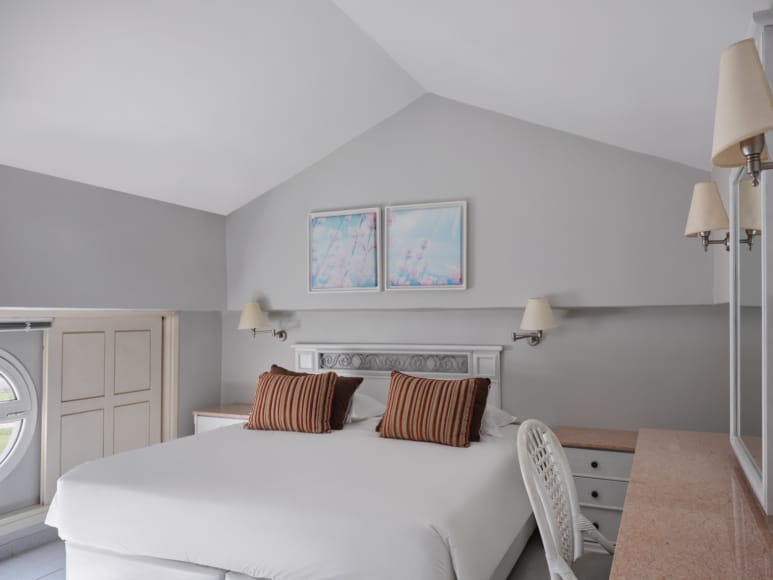 a bedroom with a bed and lamps