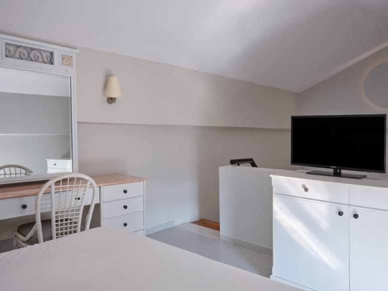 a room with white cabinets and a tv