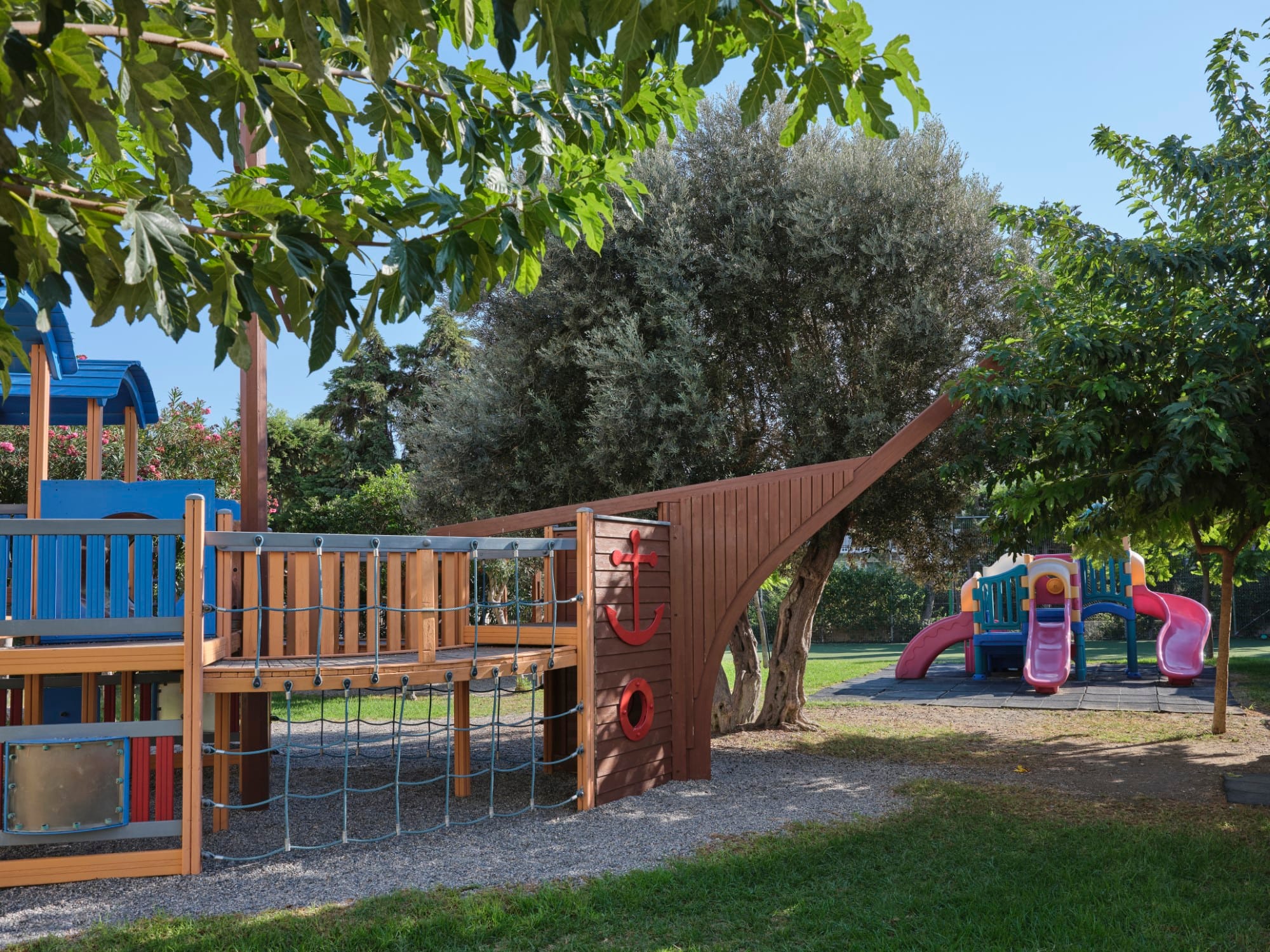 a playground with trees and a slide