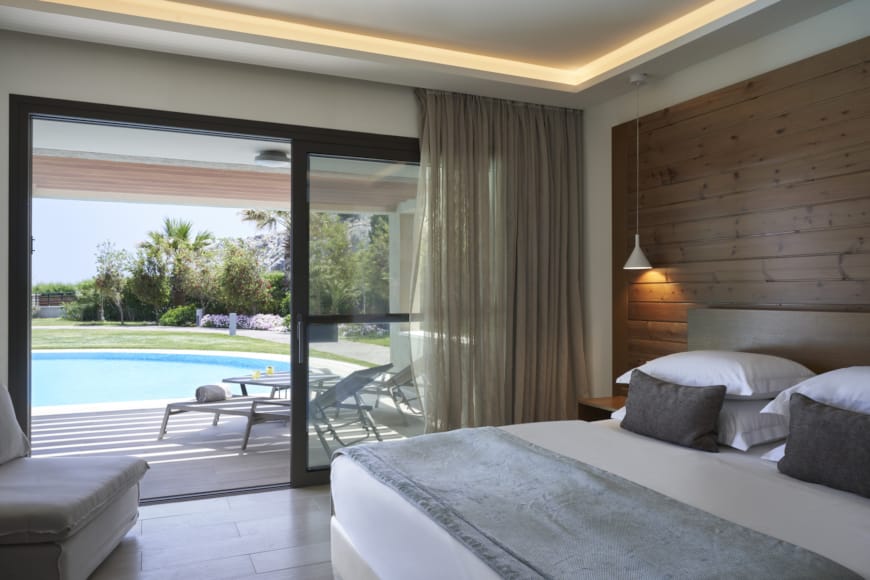 a bedroom with a large glass door