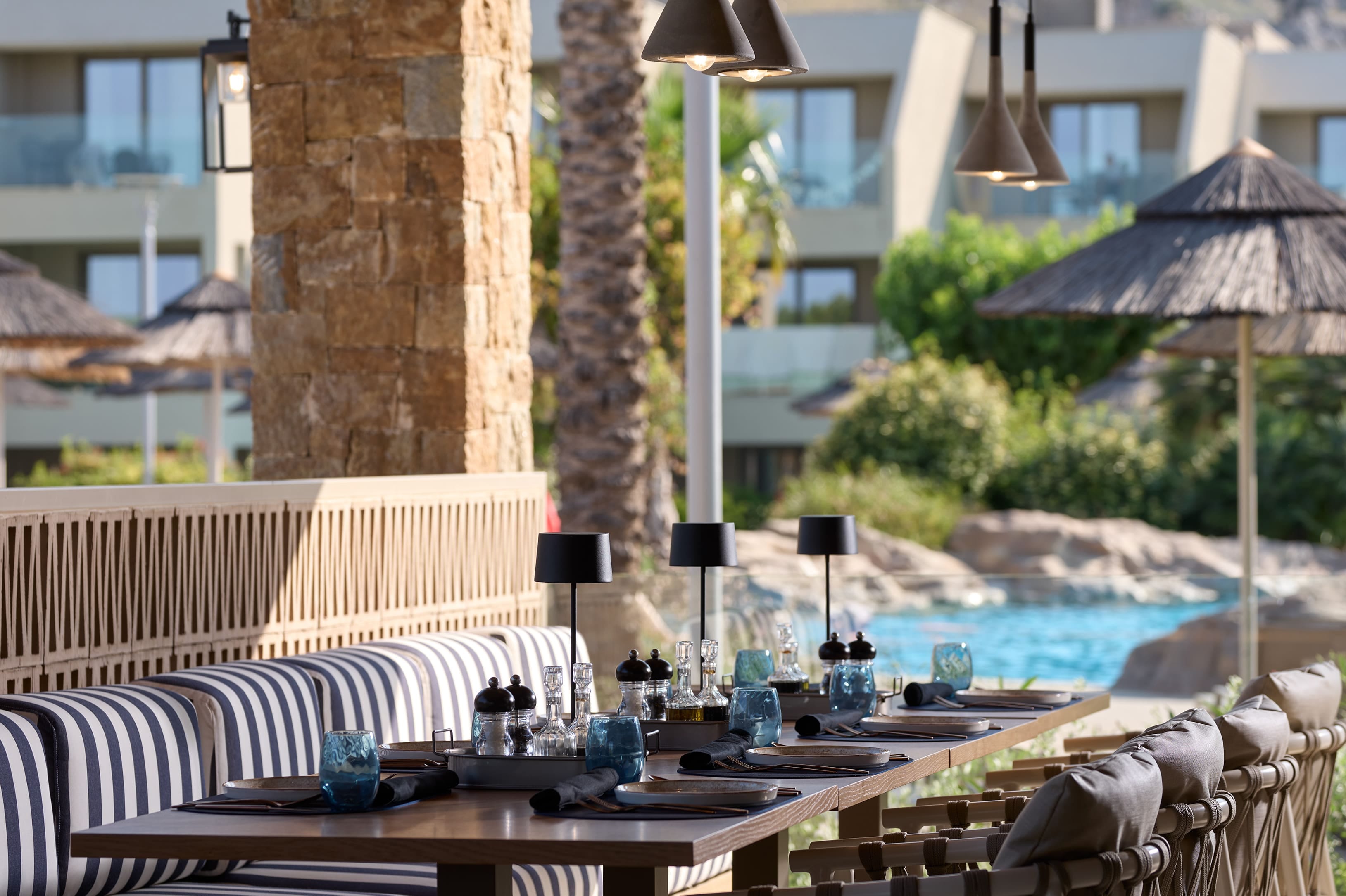 a pool with chairs and umbrellas