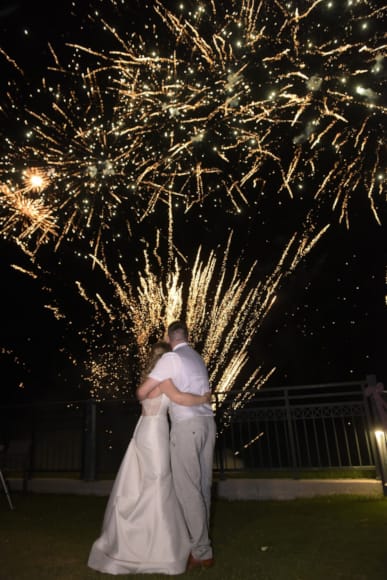 a man and woman kissing under a tree at night