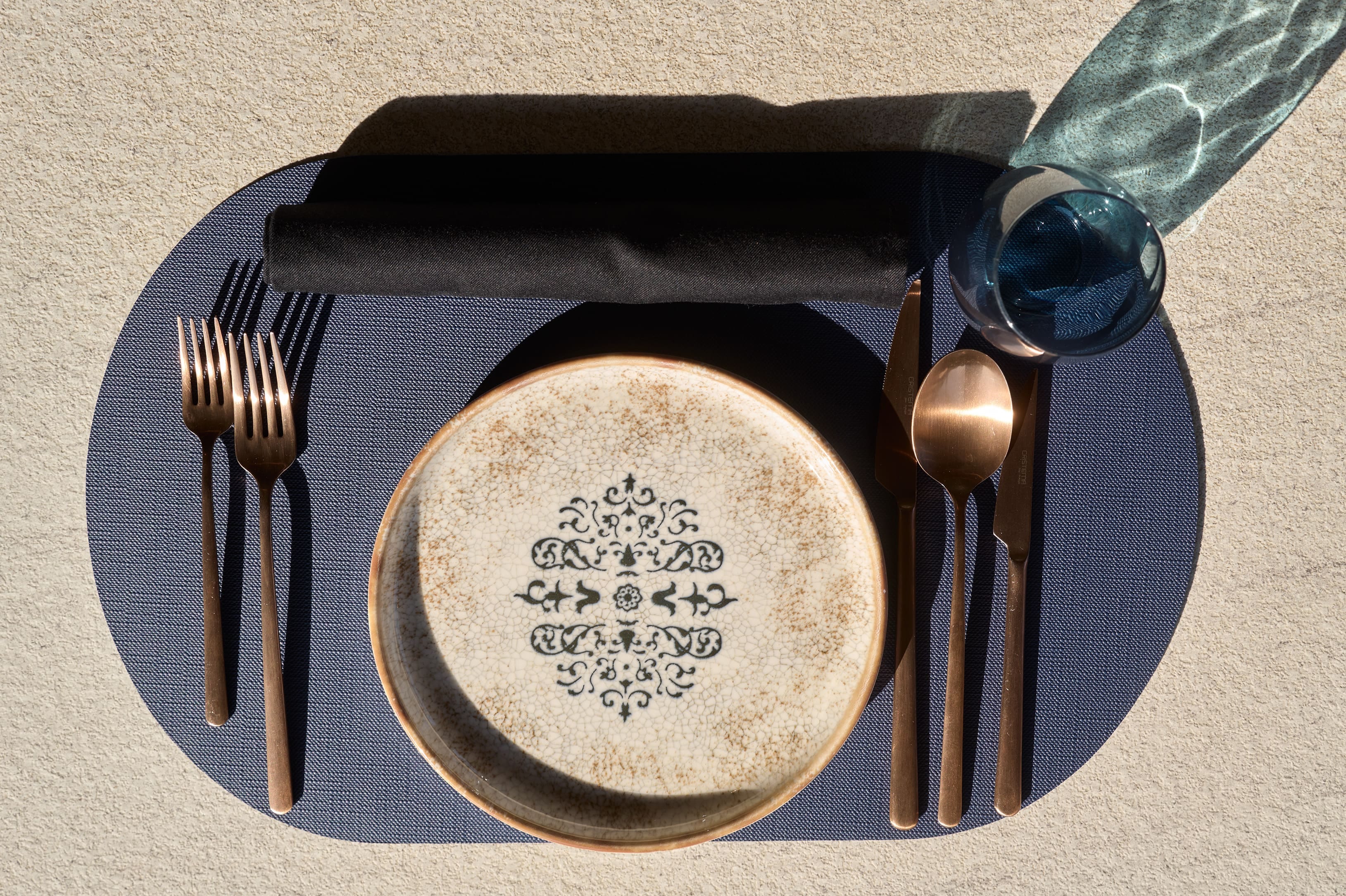 a plate with a silverware and a silver spoon on it