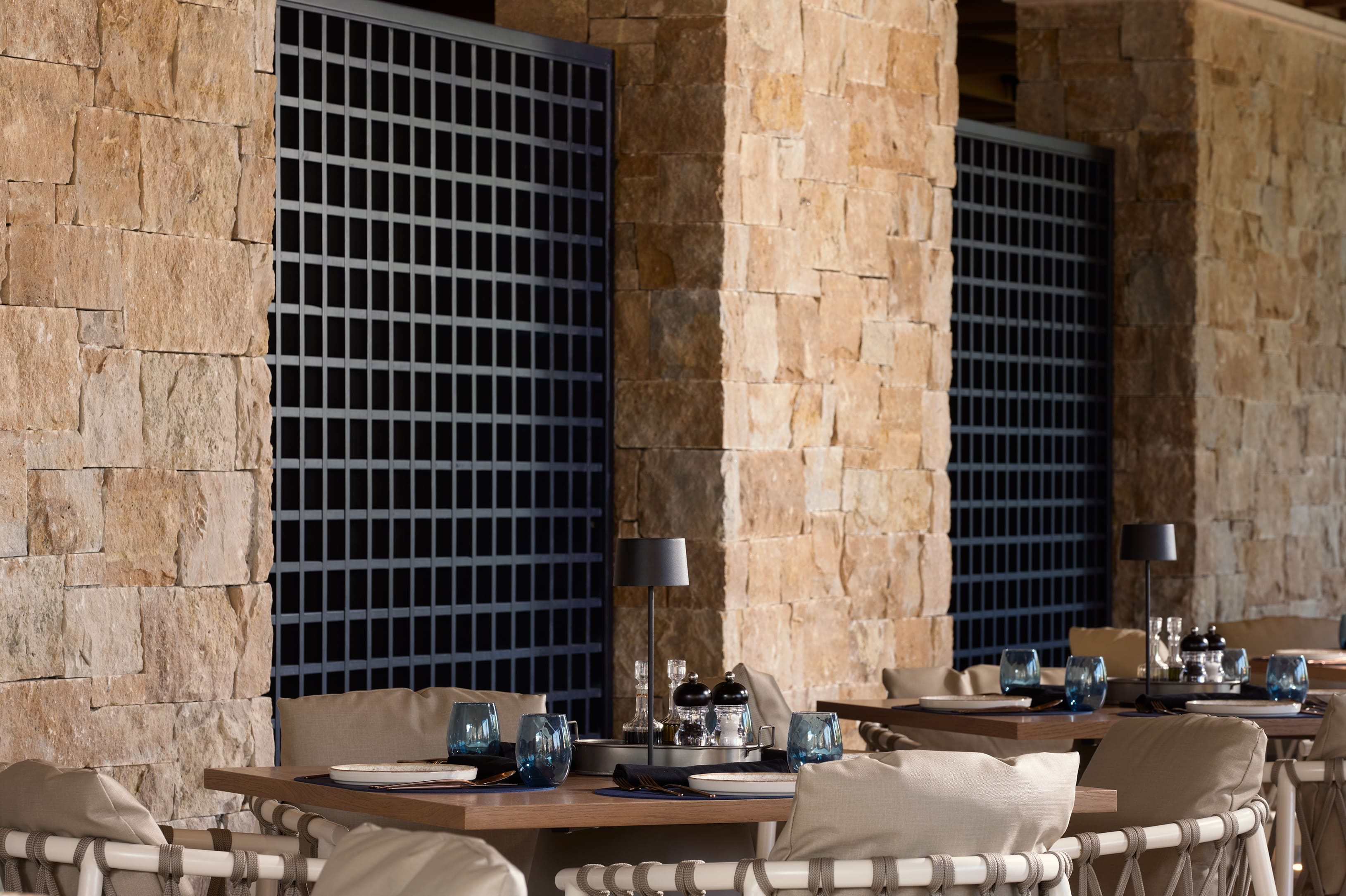 a kitchen with a stone wall