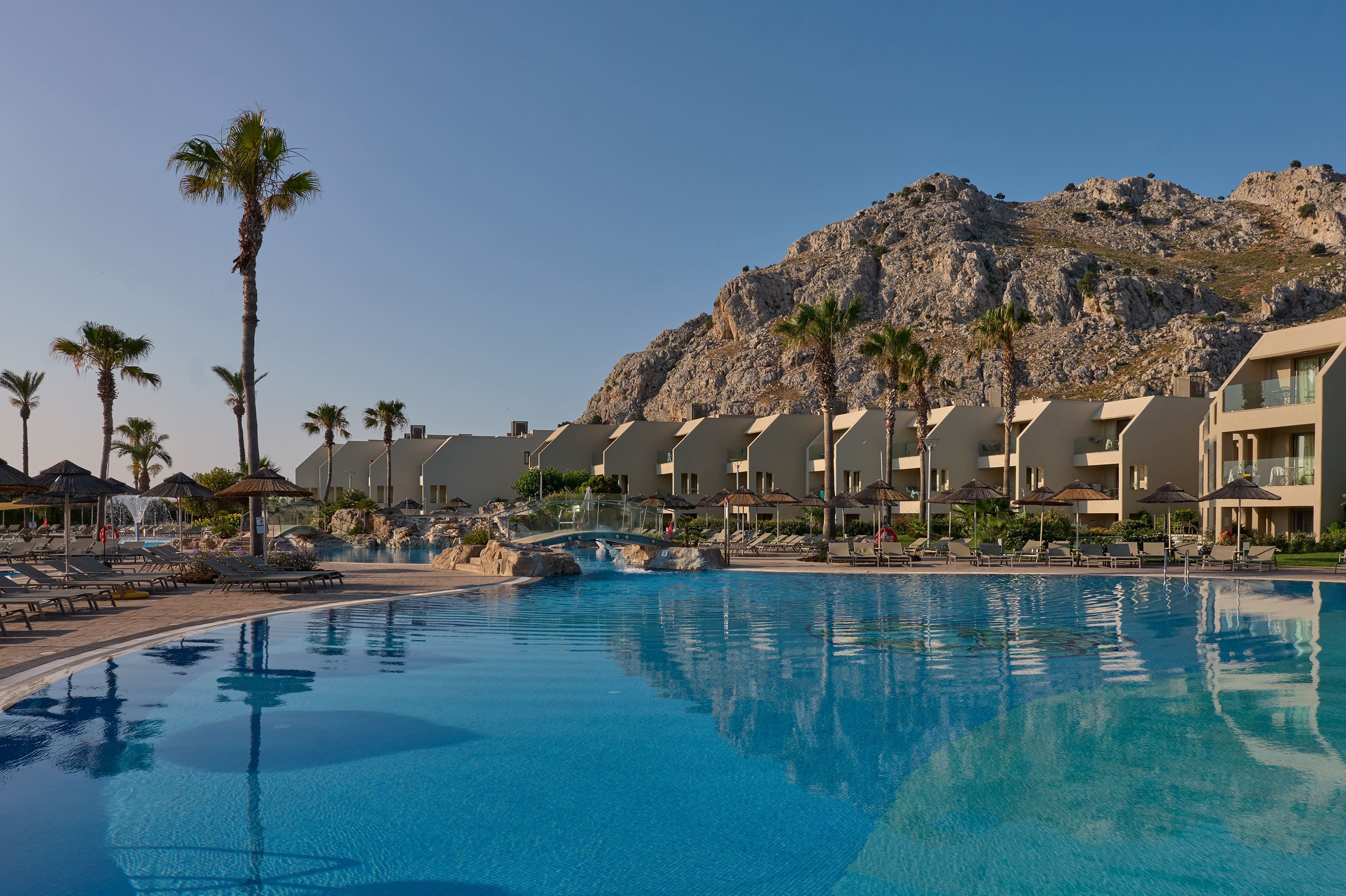 a pool with a hill in the background
