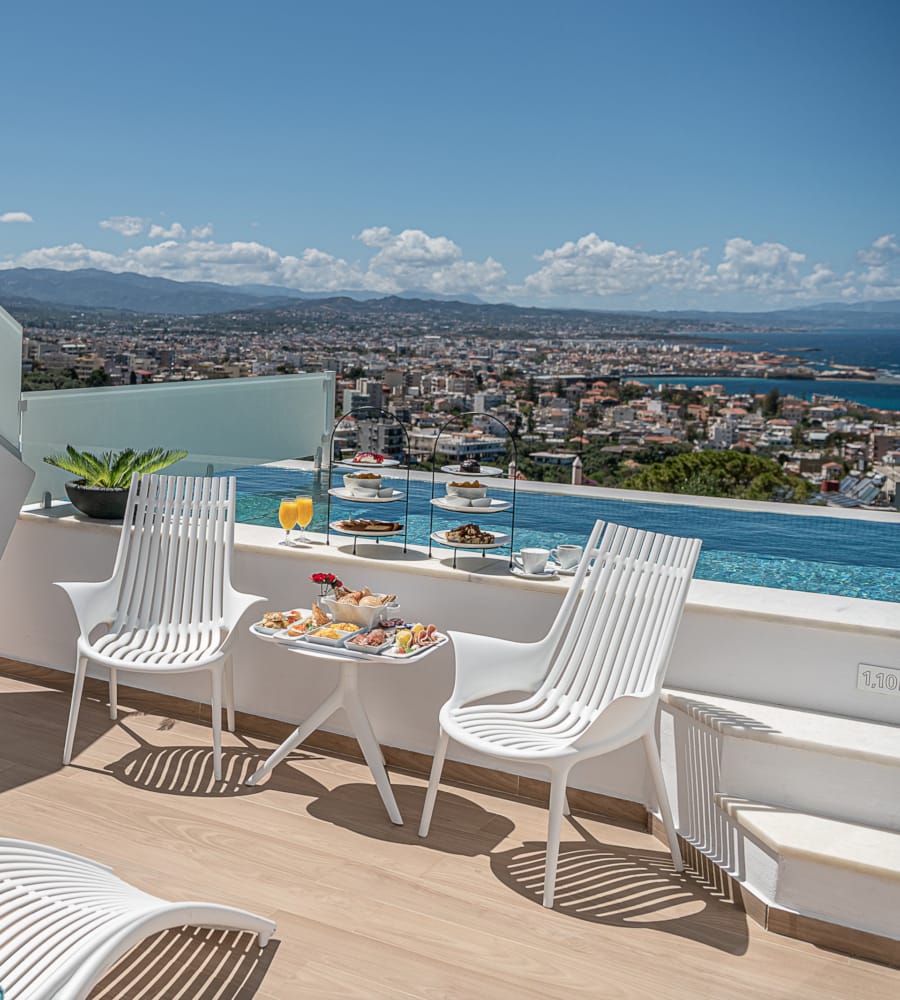 a table and chairs on a deck overlooking a city