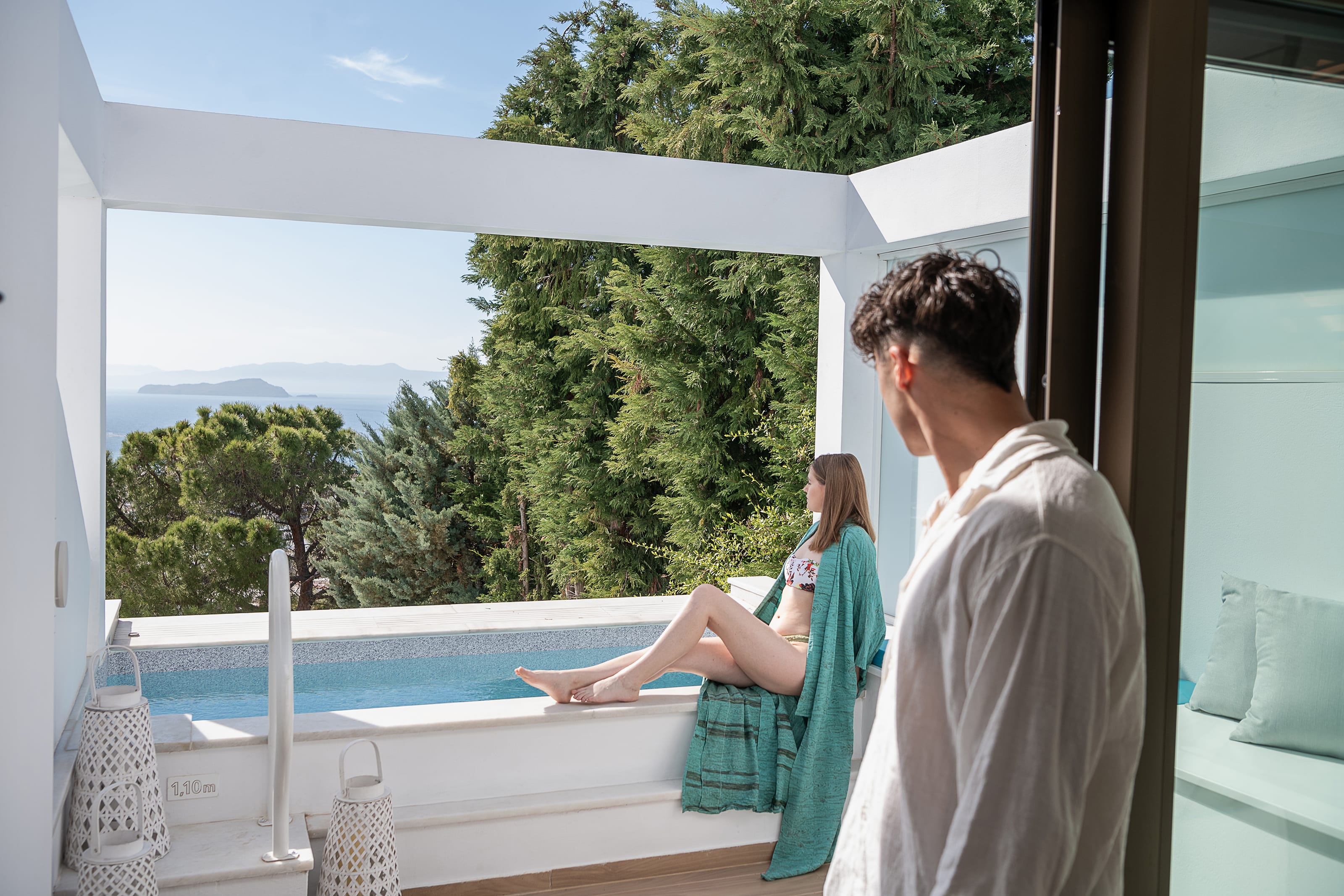 a man and woman standing by a pool