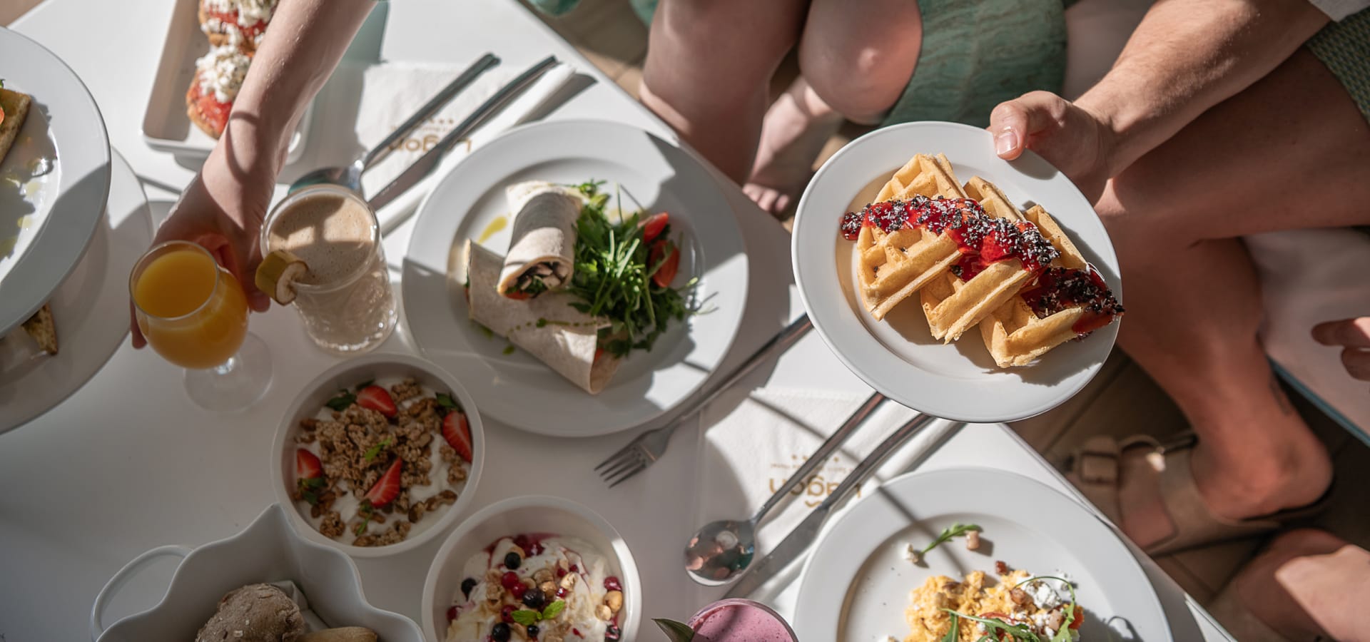 people sitting at a table with food