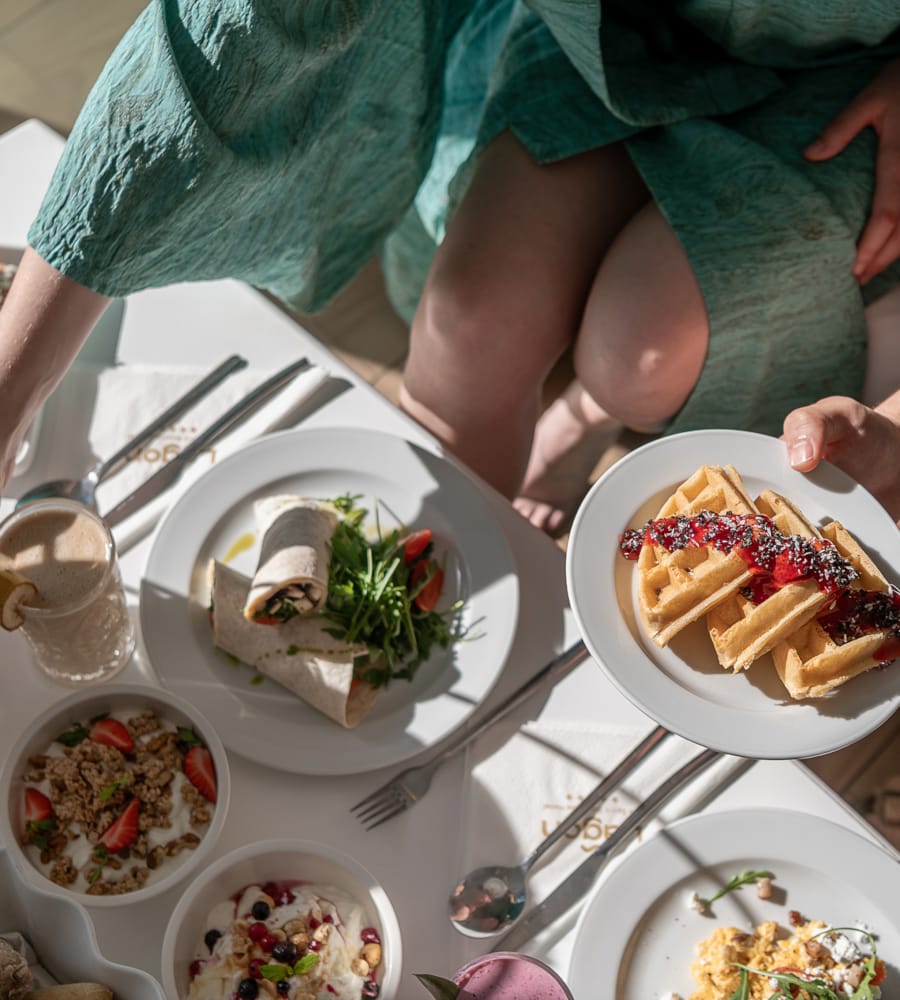 people sitting at a table with food