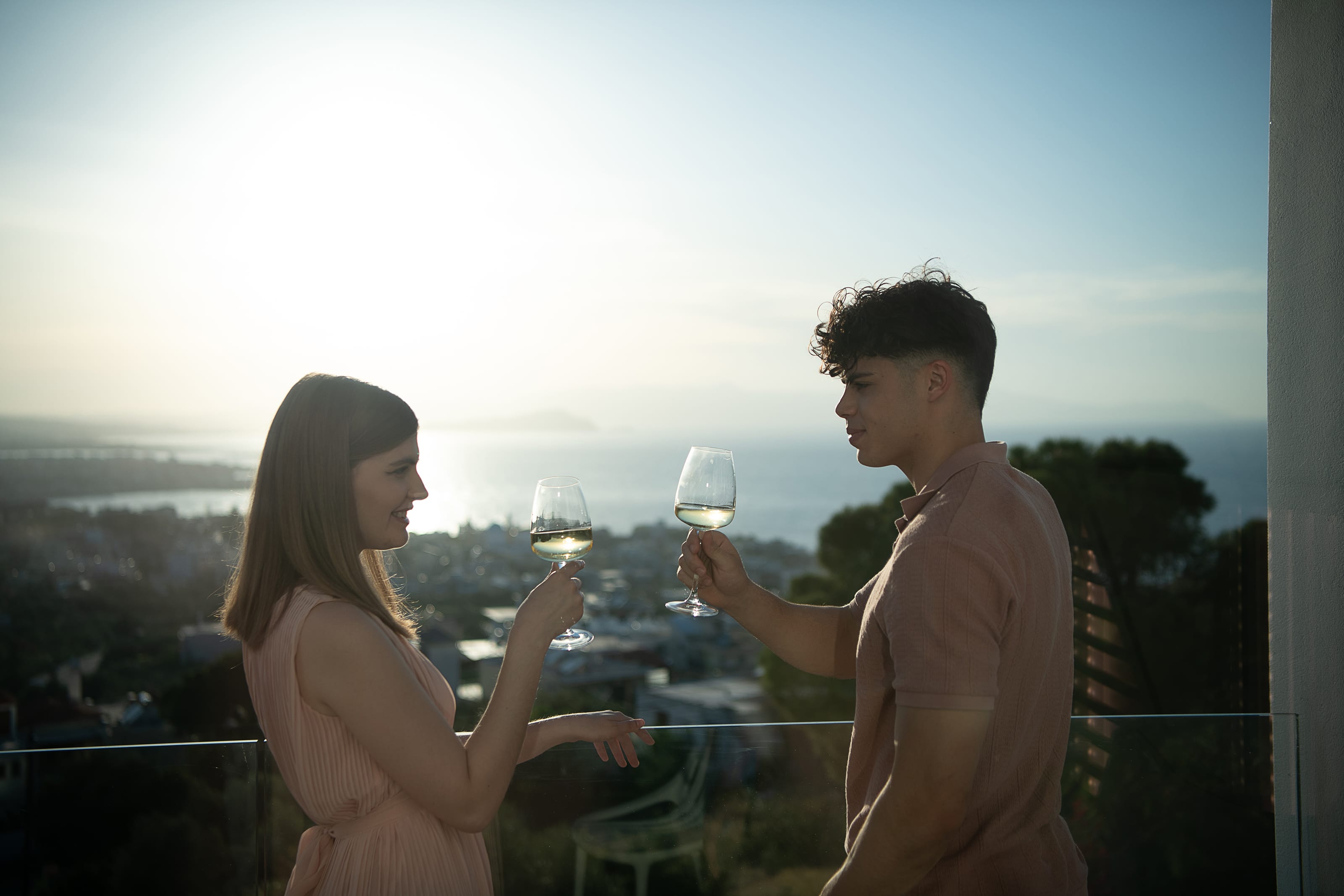 a man and woman holding wine glasses