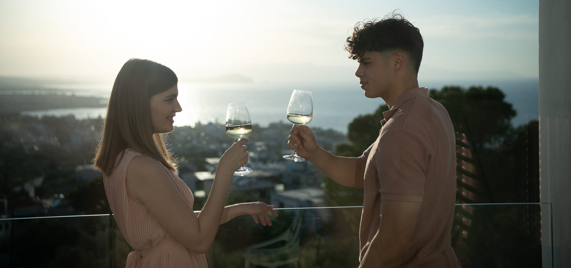a man and woman holding wine glasses