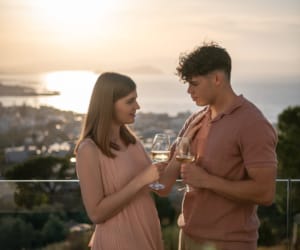 a man and woman holding wine glasses