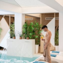 a person standing next to a pool