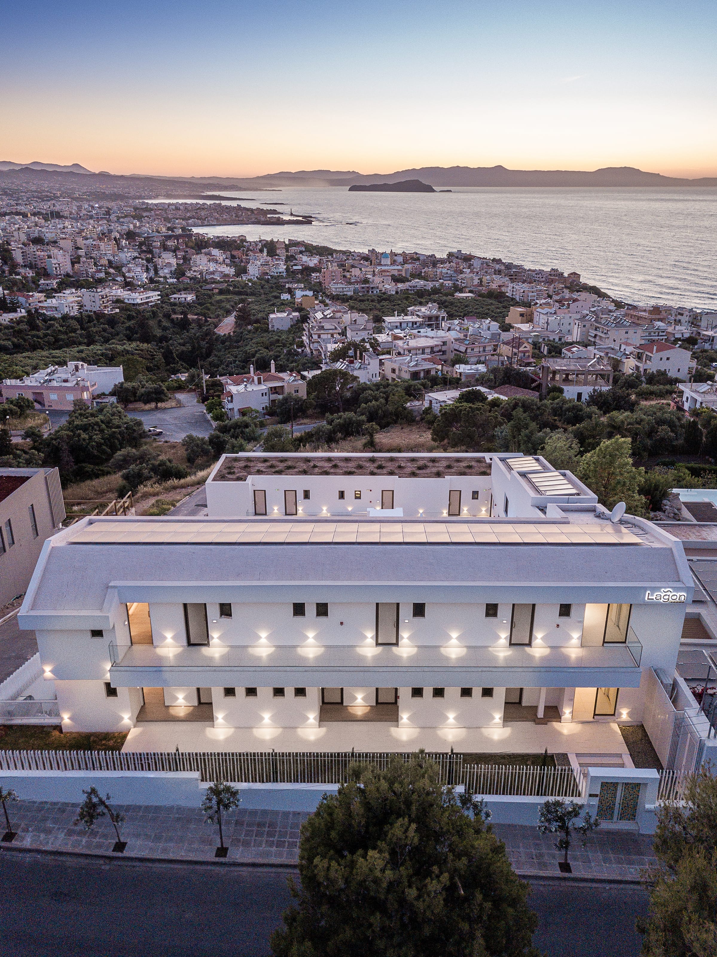 a building with a body of water in the background
