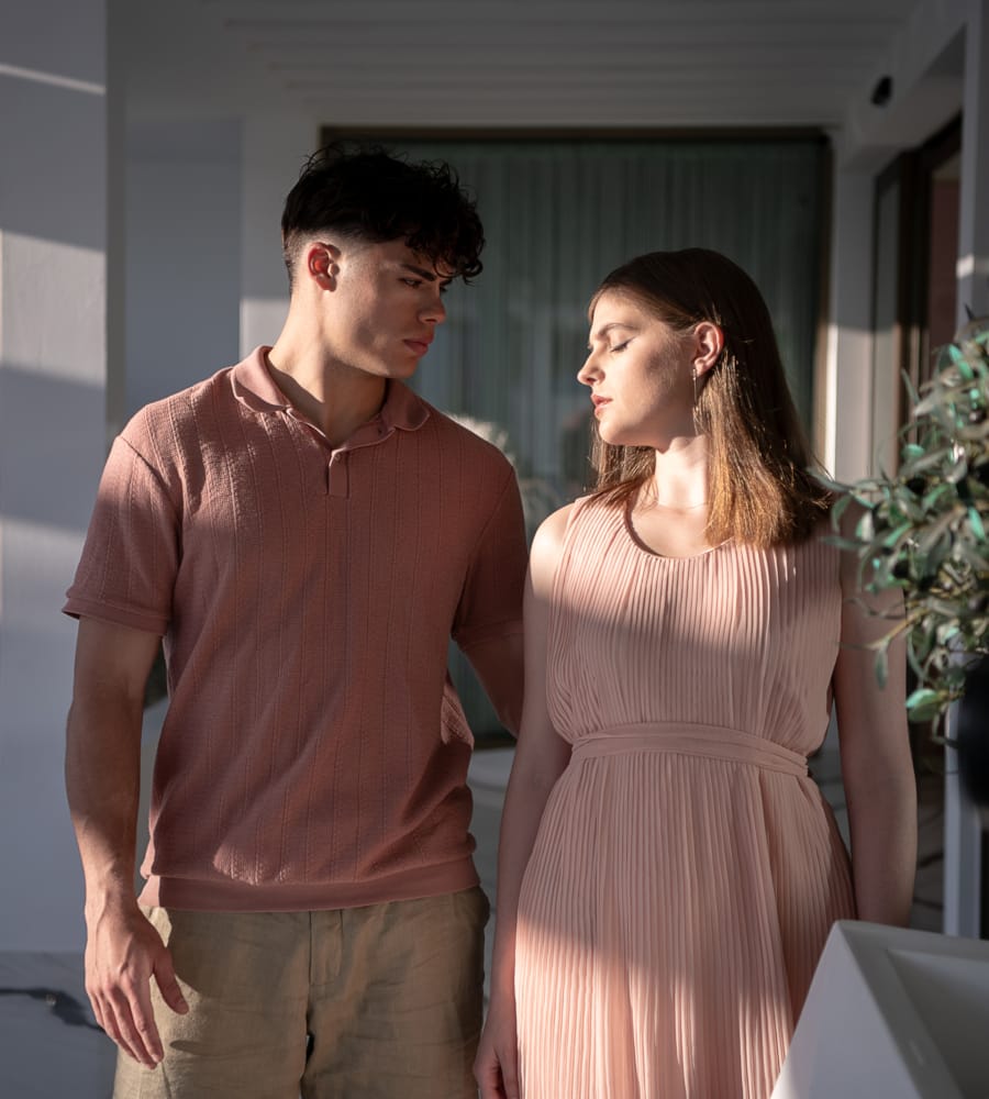 a man and woman standing next to each other and looking at each other