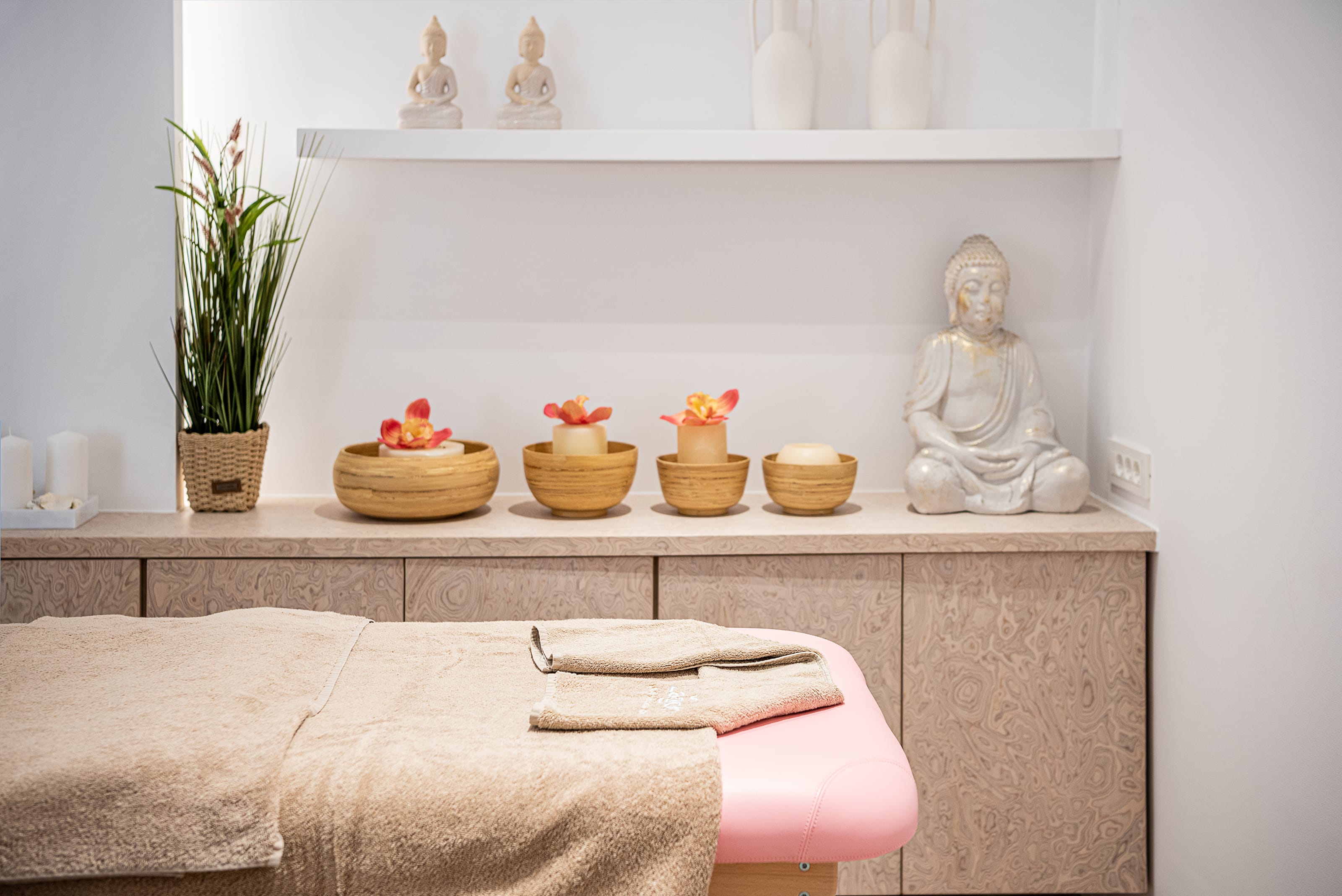 a white shelf with a statue and a white shelf with objects on it