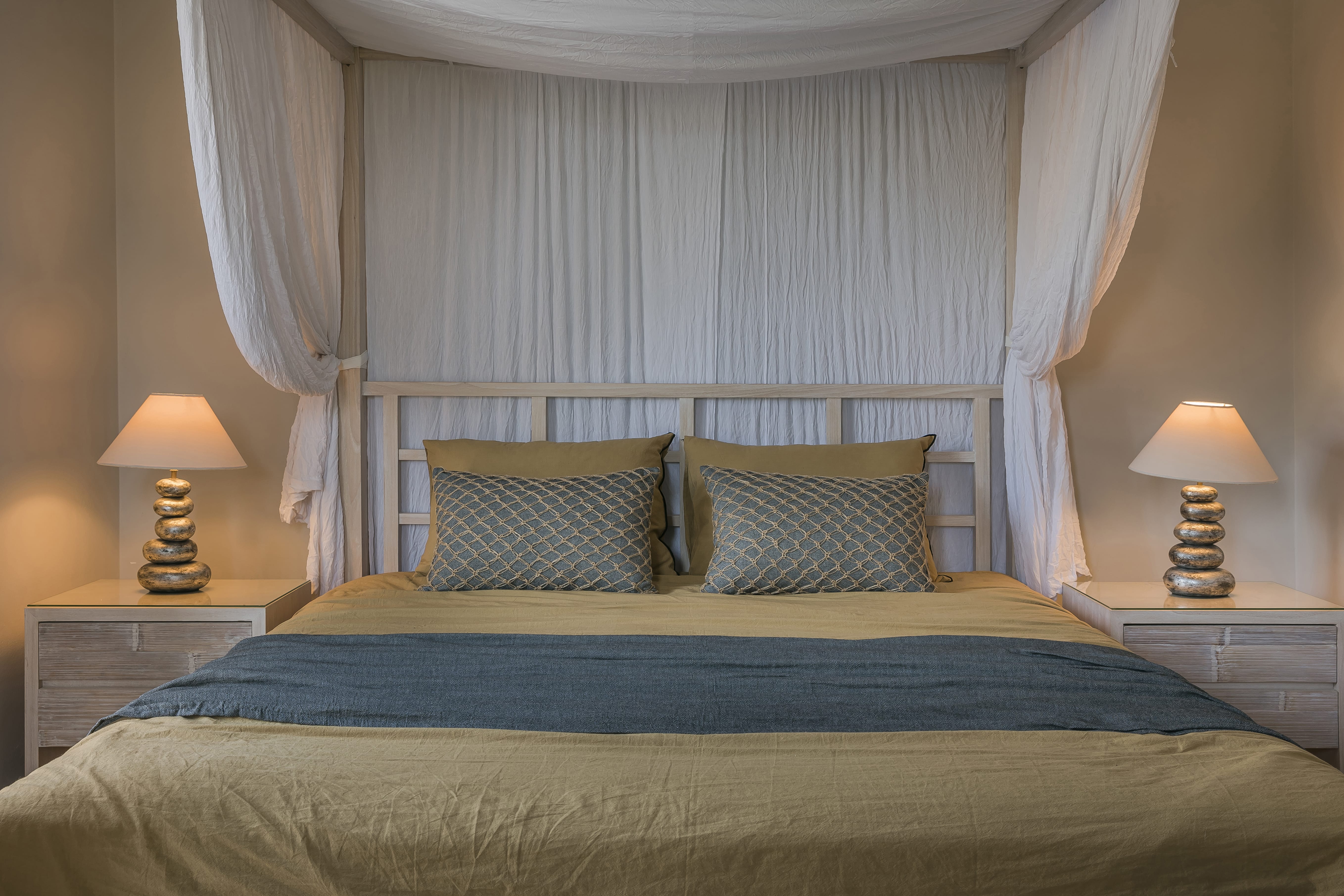 a bed with a blue and white comforter