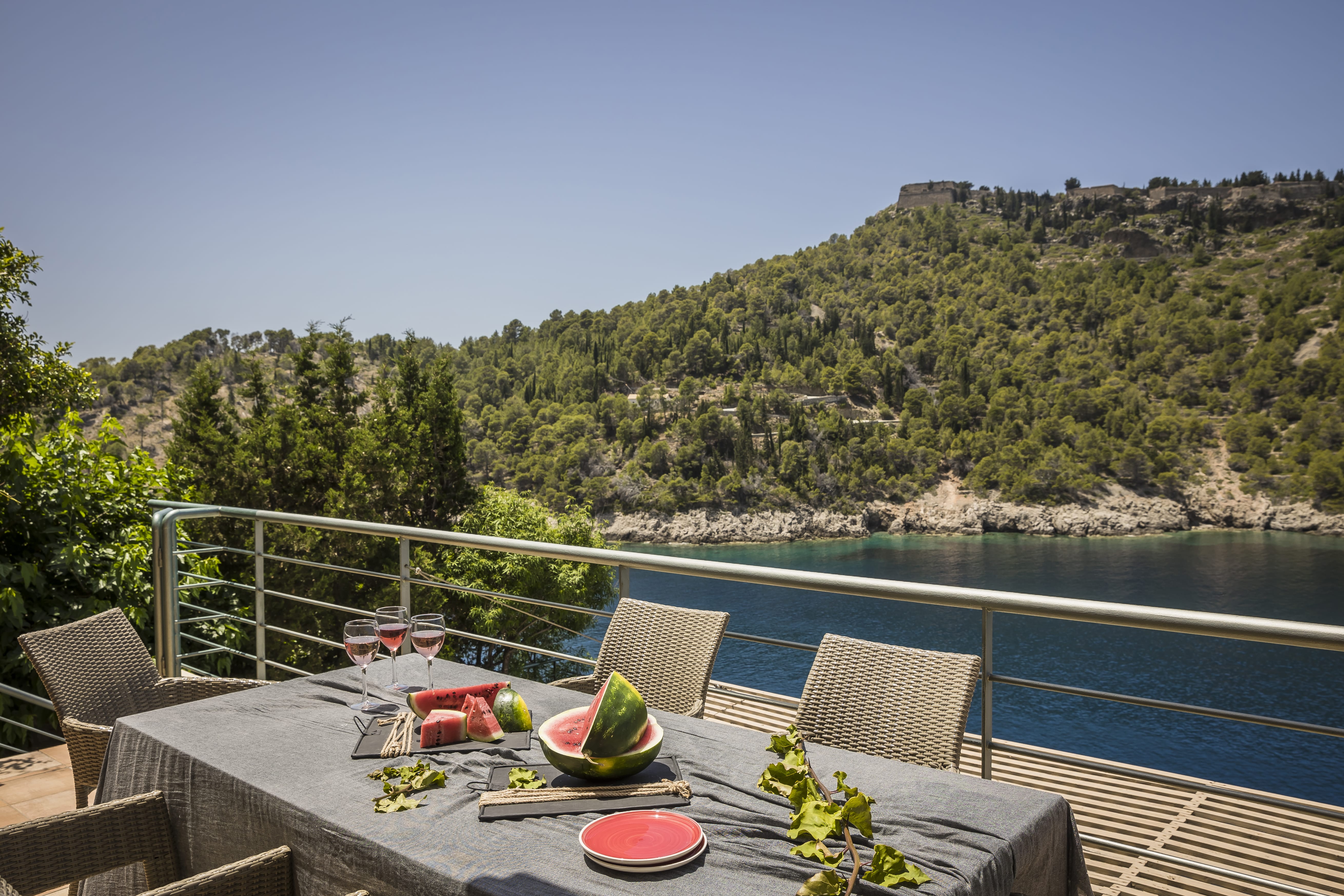 a table with food and drinks on it by a body of water