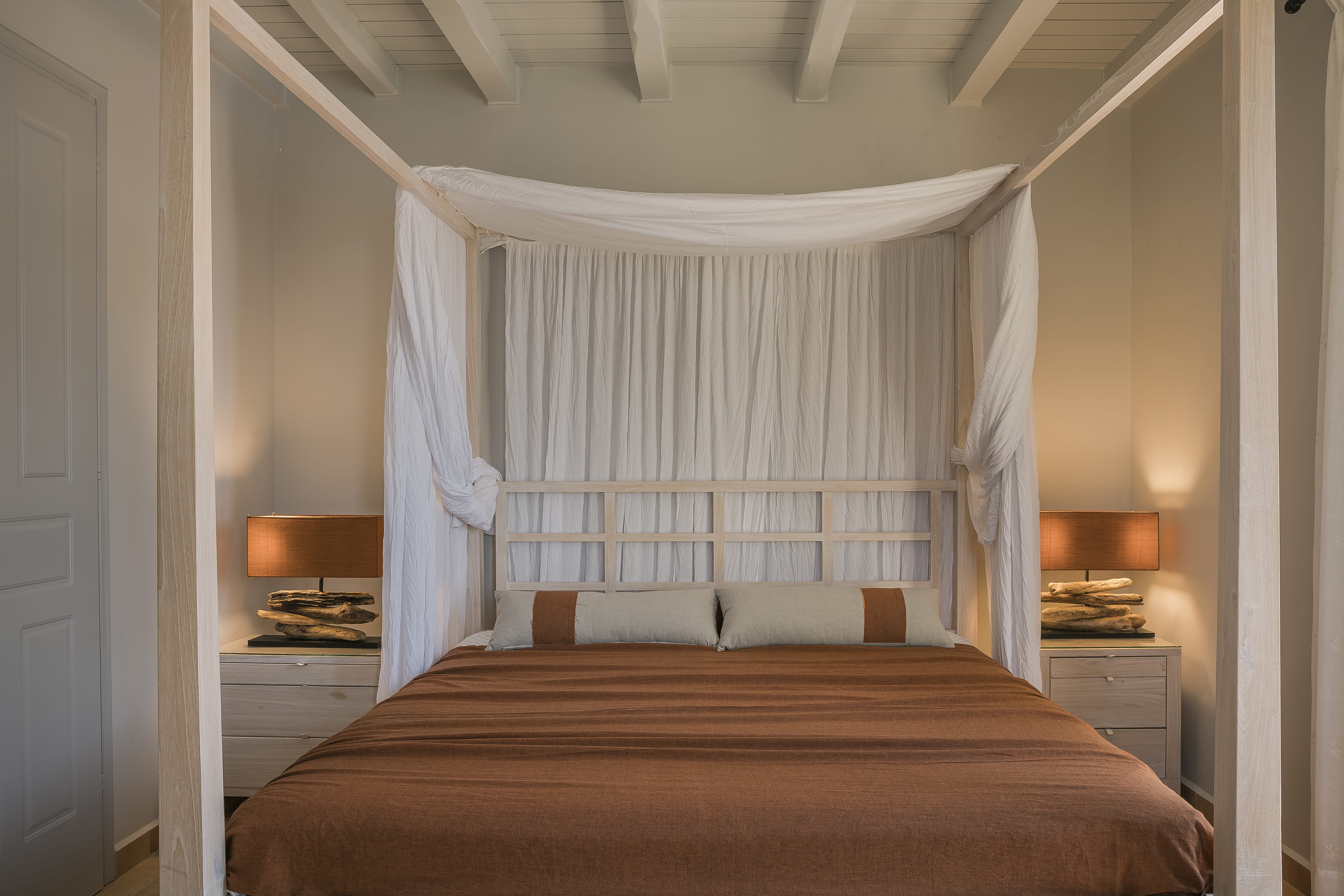 a bed with a white curtain