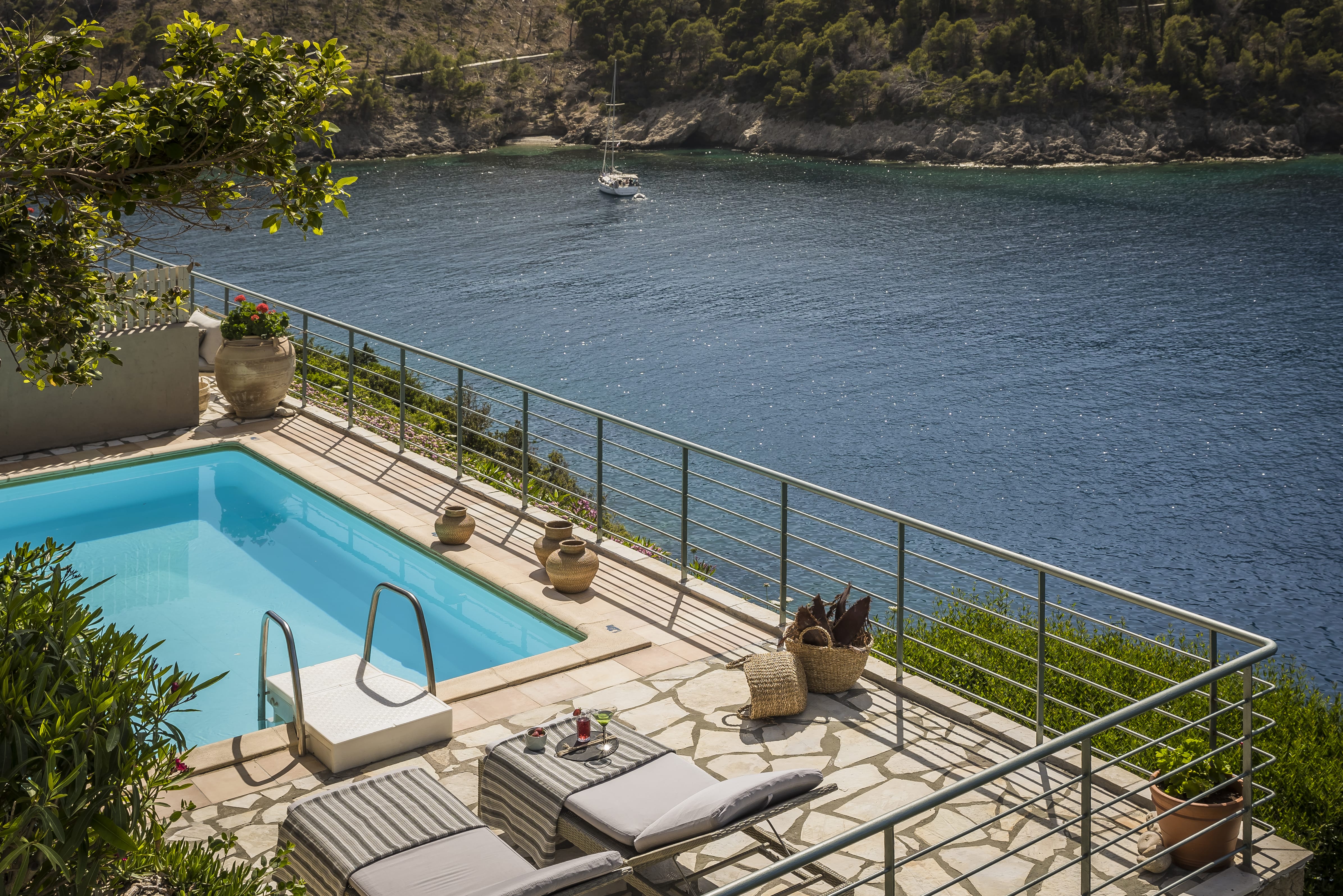 a pool with a deck and chairs