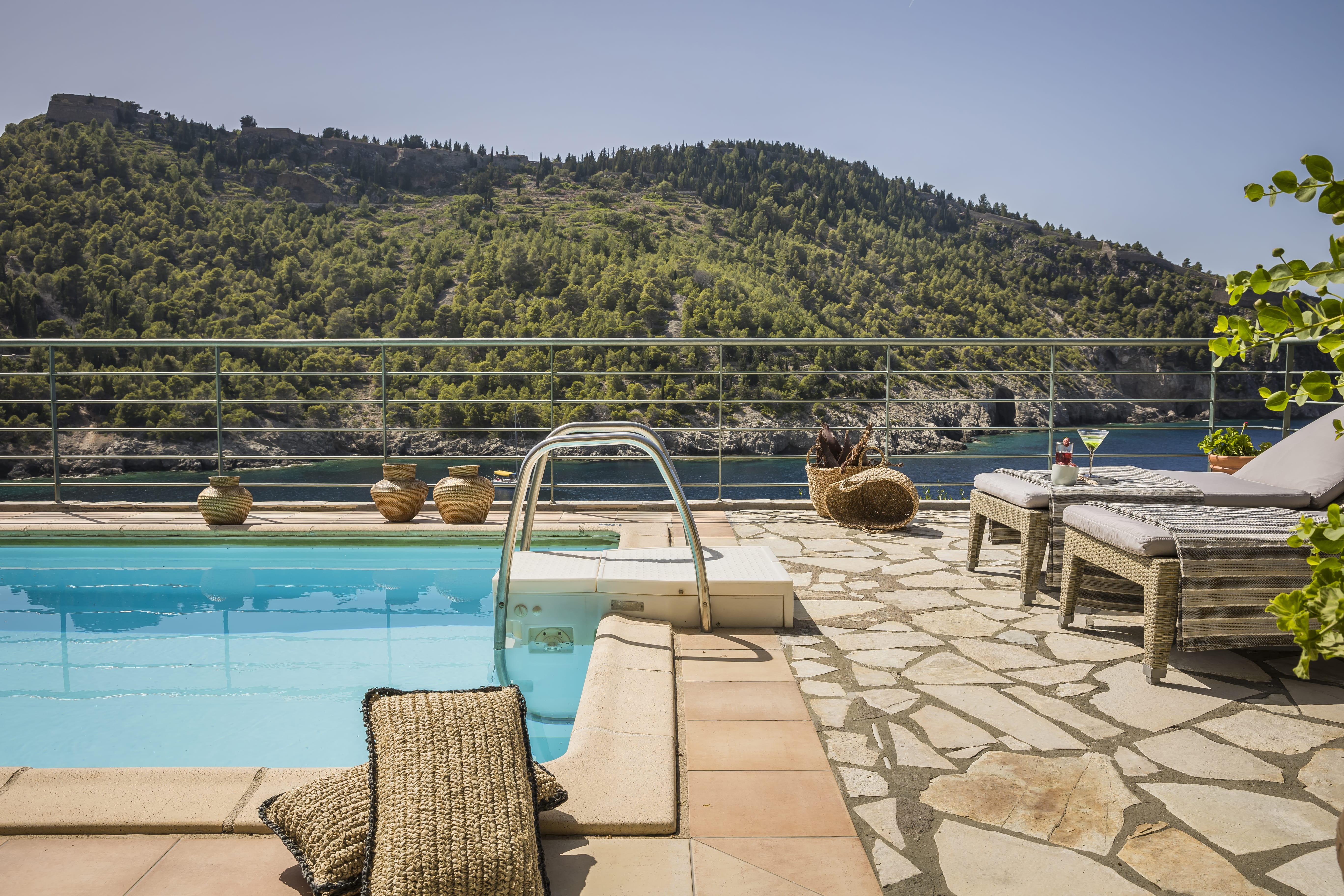 a pool with a deck and chairs