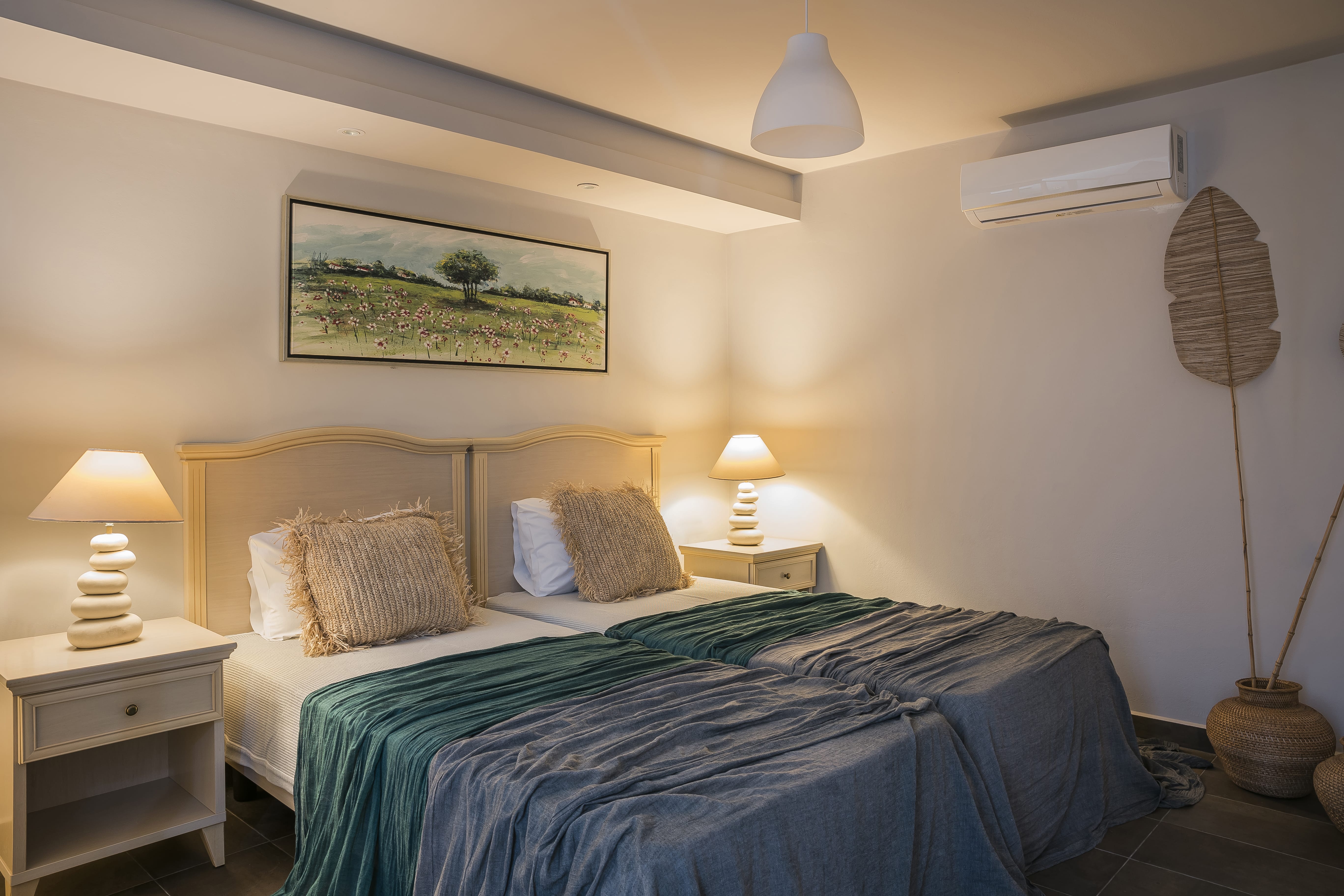 a bedroom with a bed and lamps