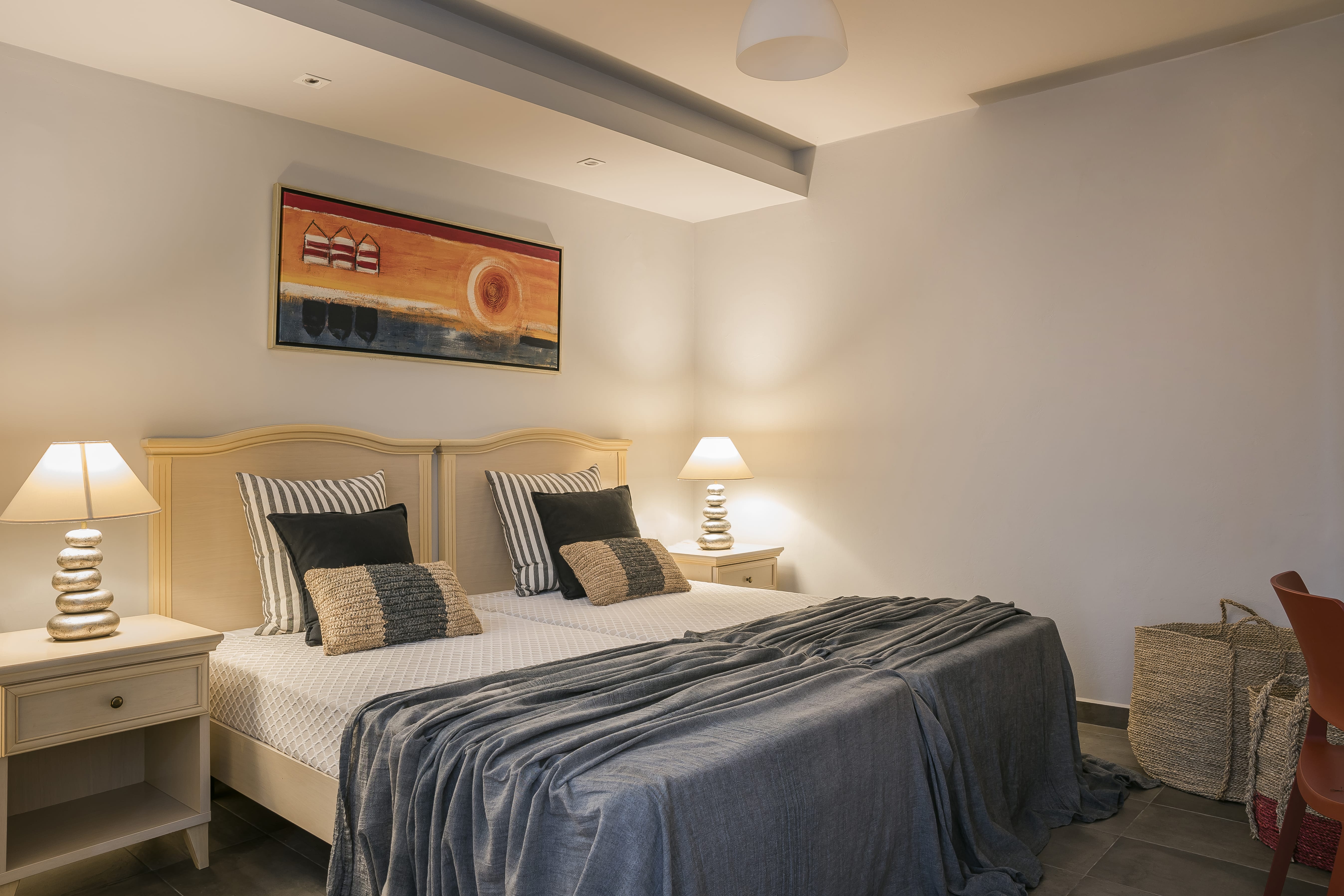 a bedroom with a bed and lamps