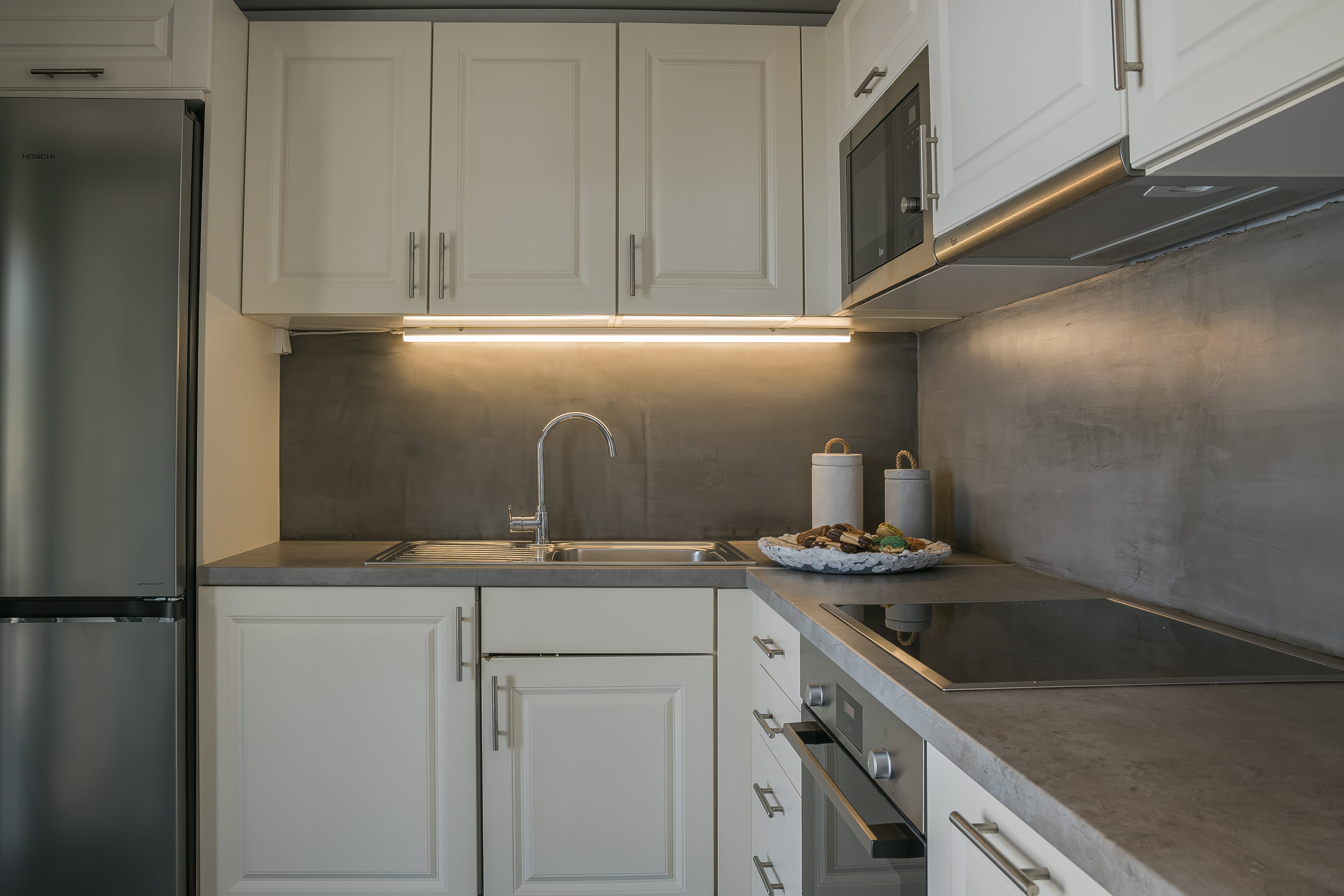 a kitchen with white cabinets