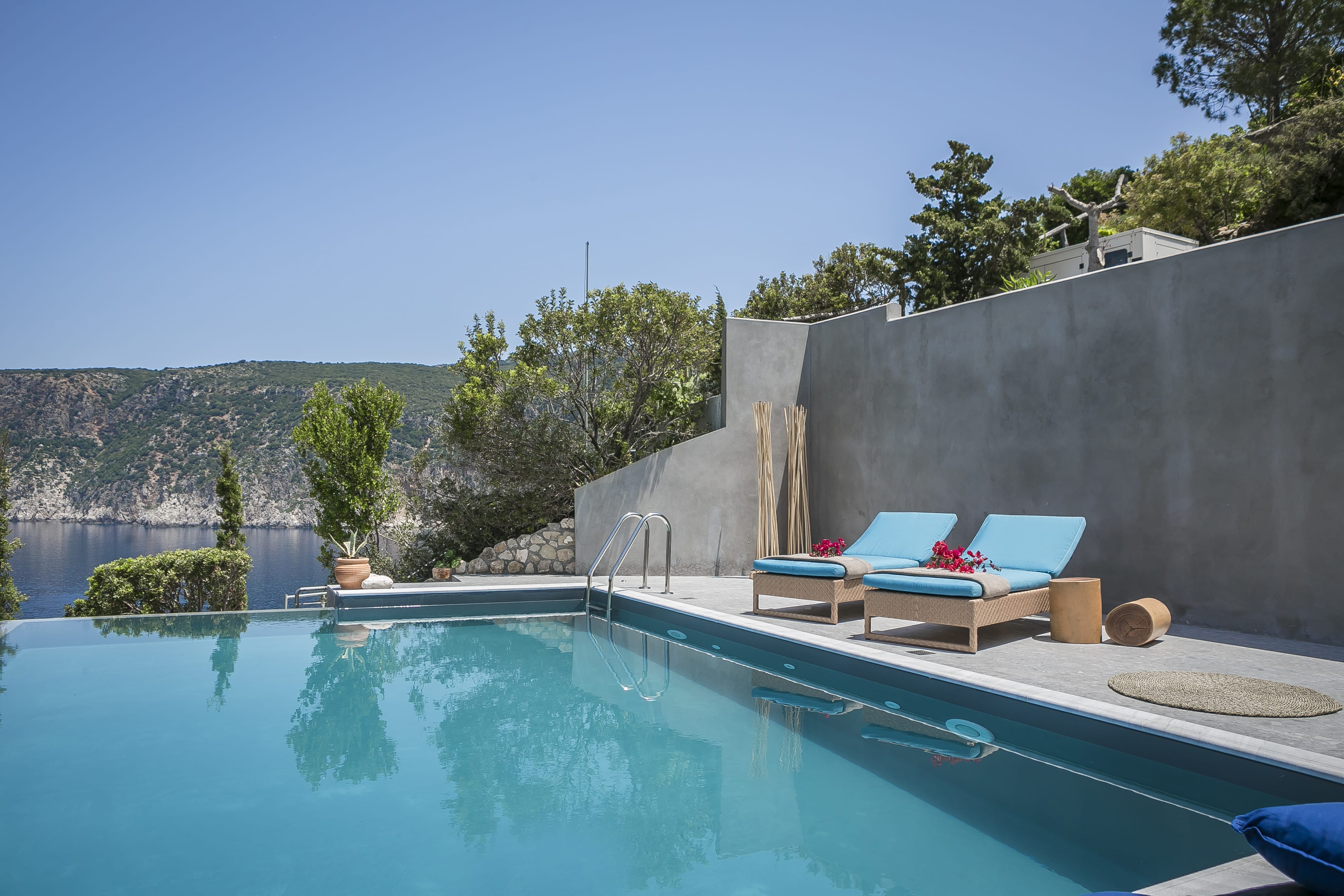 a pool with chairs and a wall